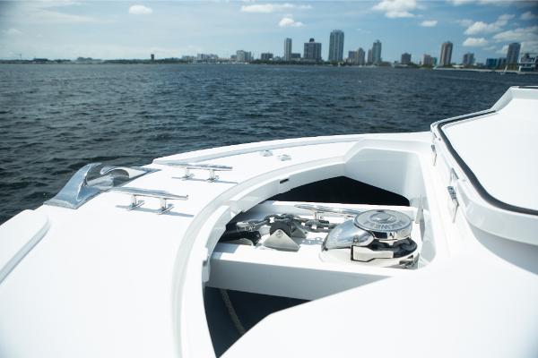 Slide: The Image of 2023 Bertram 50 Sport yacht bow with city skyline in the background. - 49