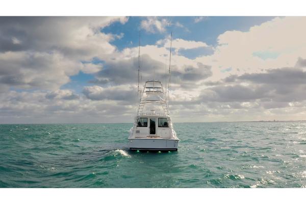 Slide: The Image of 2023 Bertram 50 Sport yacht on open sea under cloudy sky. - 5