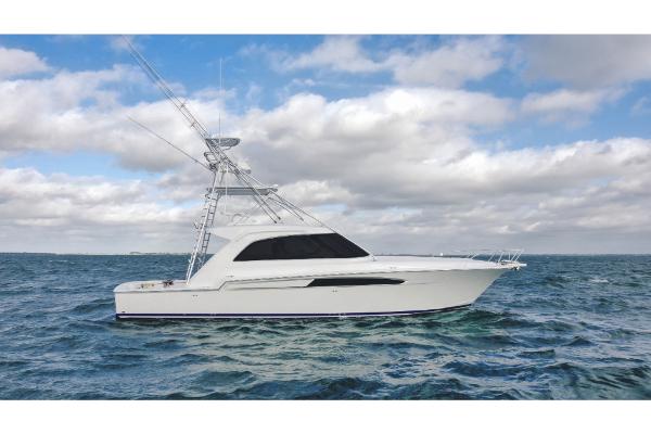 Slide: The Image of 2023 Bertram 50 Sport yacht on open water under cloudy sky. - 6