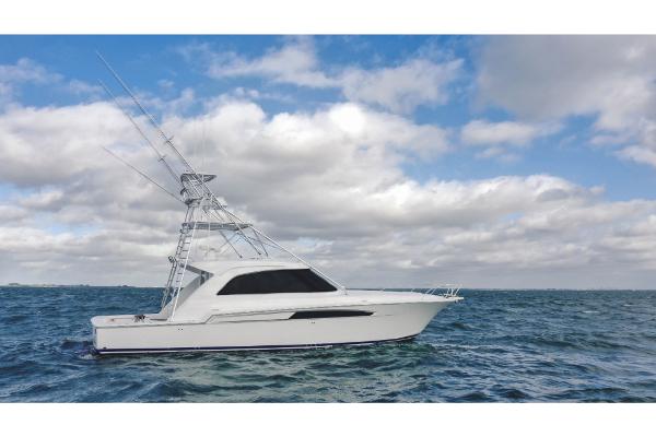 Slide: The Image of 2023 Bertram 50 Sport yacht on open water under cloudy sky. - 7