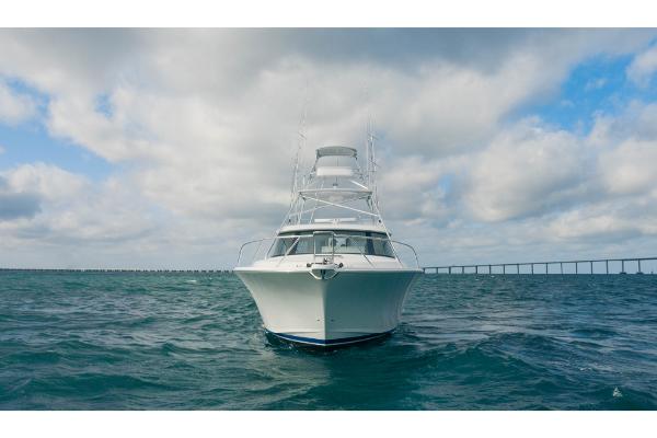 Slide: The Image of 2023 Bertram 50 Sport yacht on open water under cloudy sky. - 9