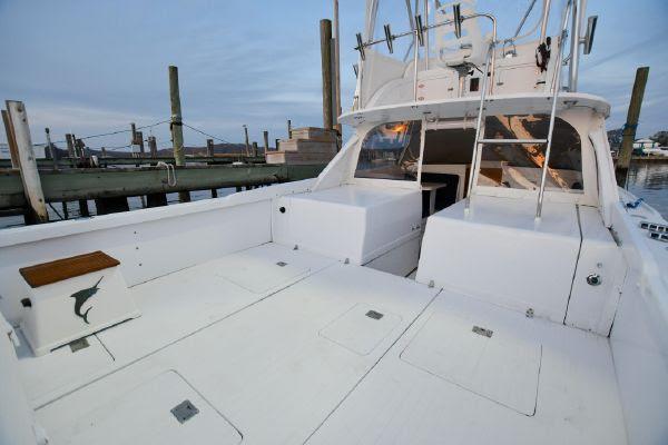 Slide: The Image of 1965 Bertram Sportfisher boat with spacious deck at a marina. - 10