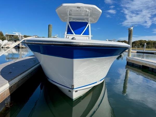Slide: The Image of 2019 Blackfin 242 CC boat docked in a marina on a sunny day. - 1