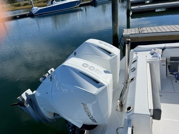 Slide: The Image of 2019 Blackfin 242 CC with twin Mercury outboard engines docked at marina. - 5