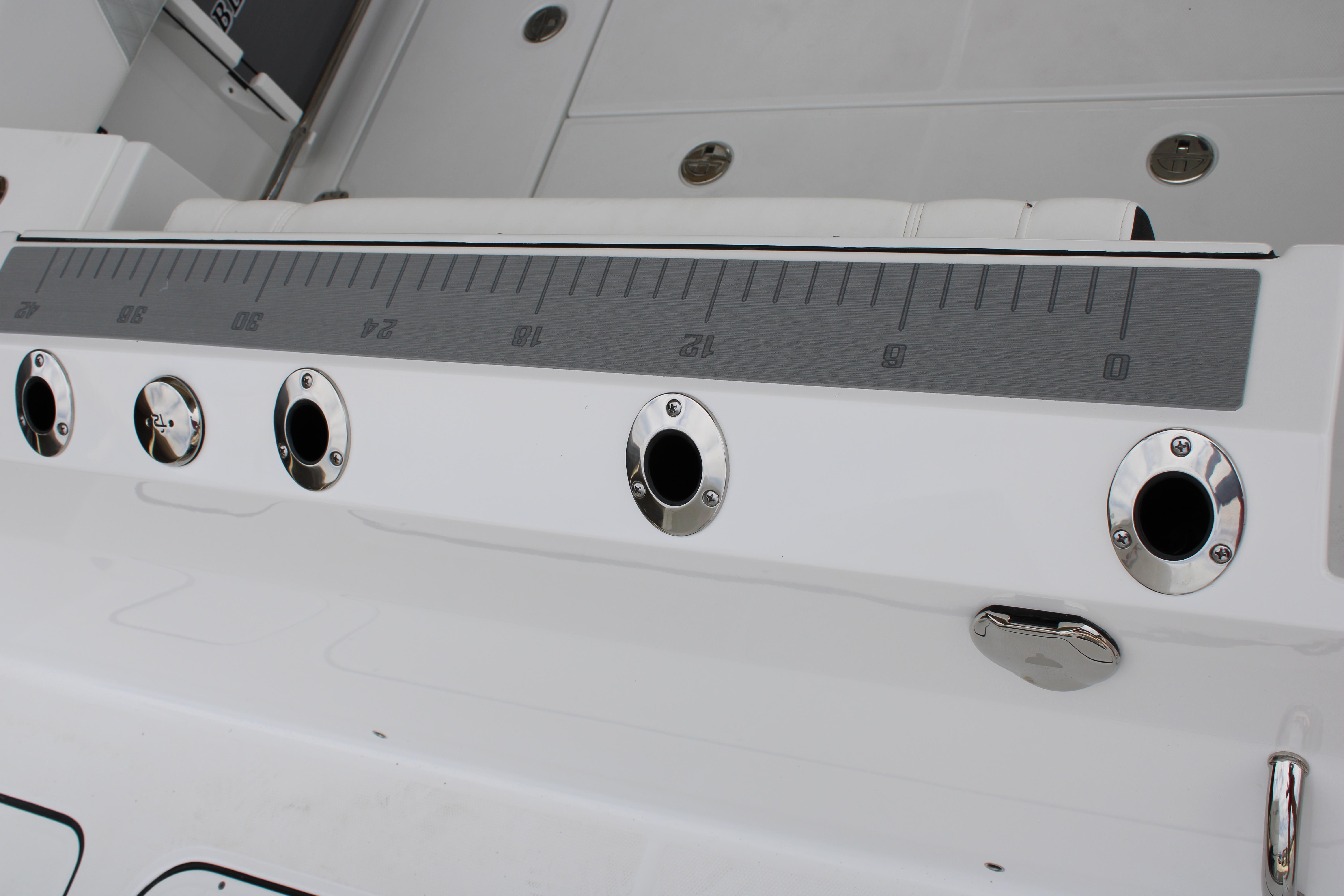 Slide: The Image of 2023 Blackfin 252 DC boat with rod holders and measuring ruler. - 10