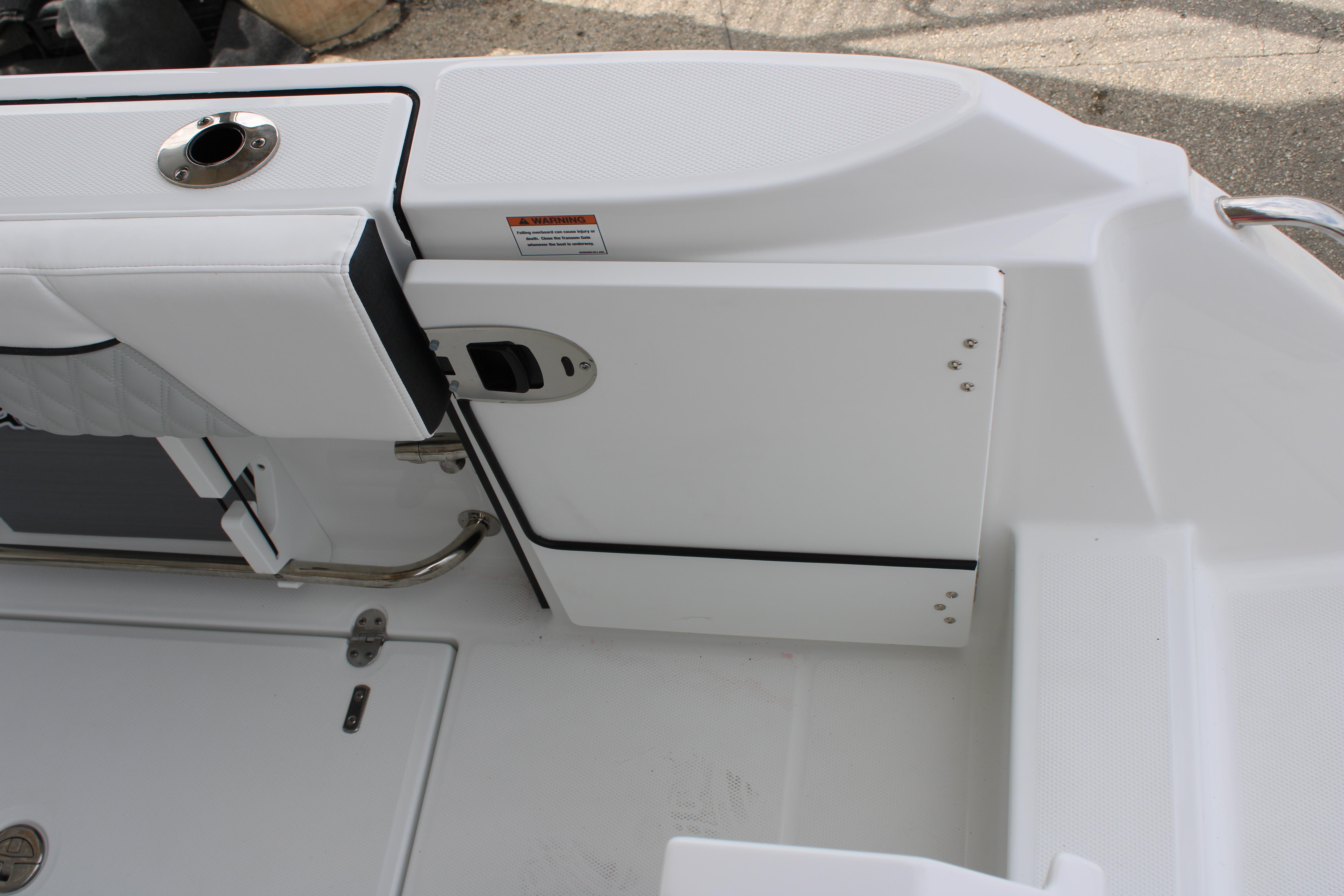 Slide: The Image of 2023 Blackfin 252 DC boat interior, featuring white seating and storage compartments. - 11