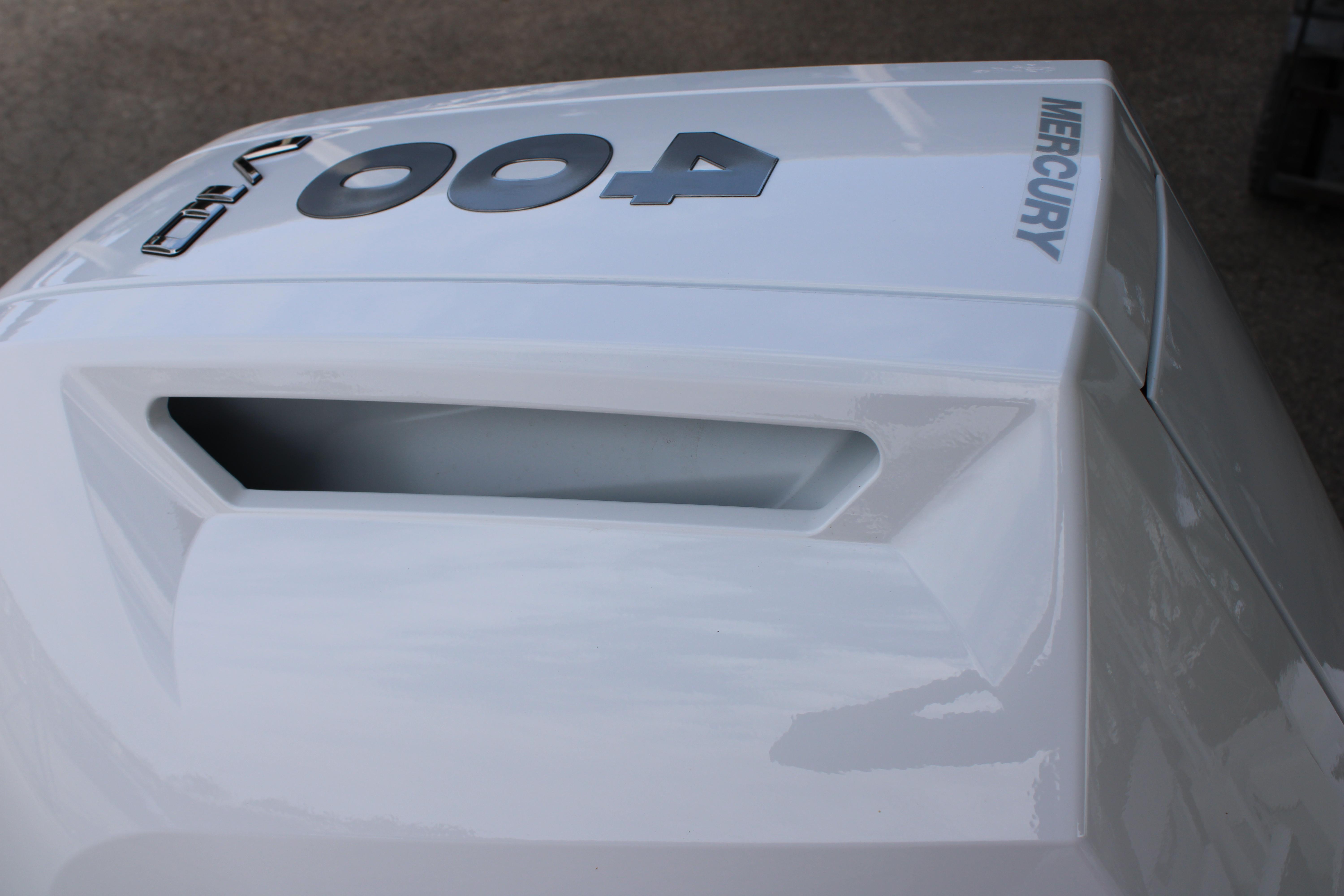 Slide: The Image of Close-up of a 2023 Blackfin 252 DC boat with a Mercury engine. - 12