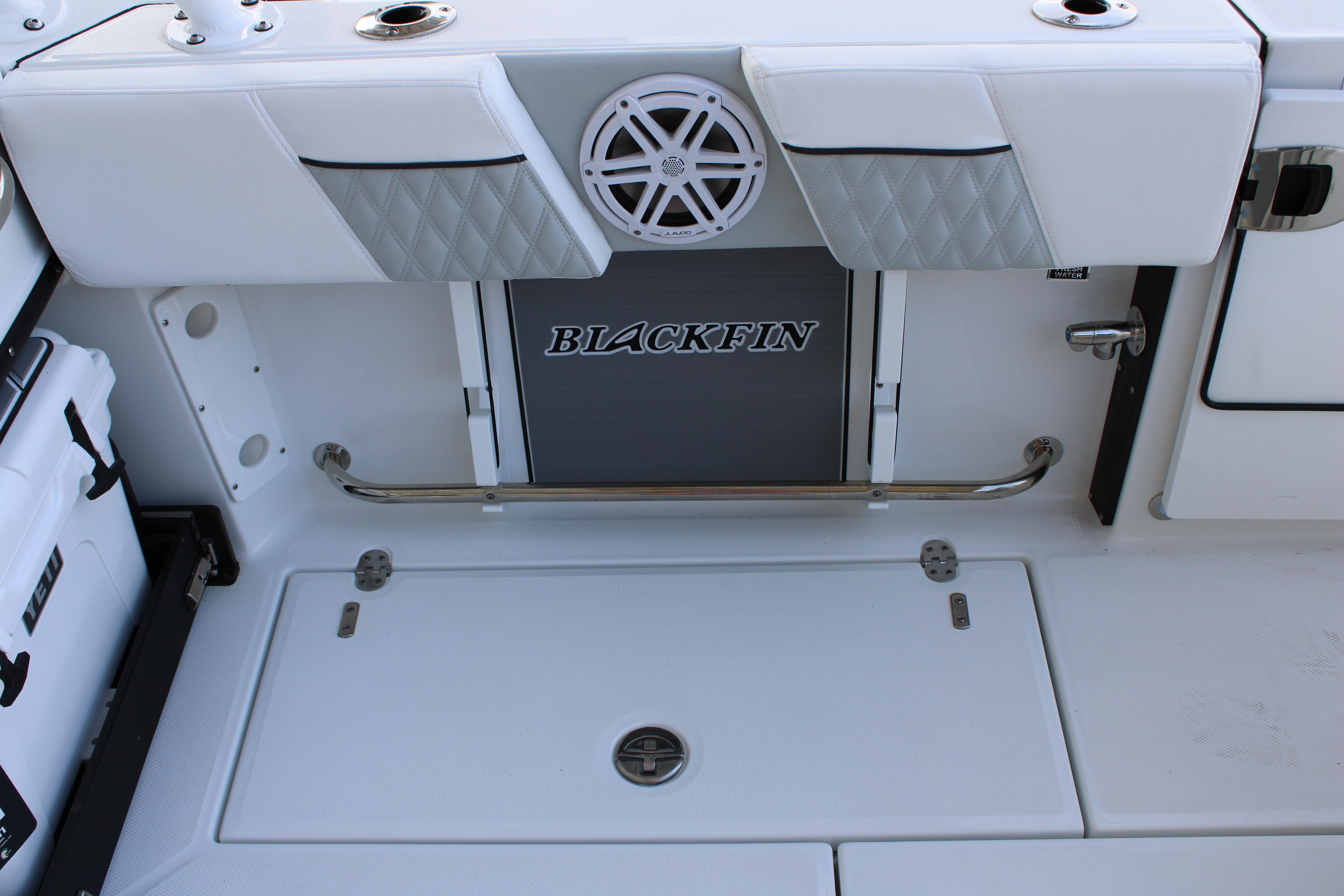 Slide: The Image of 2023 Blackfin 252 DC boat interior with storage compartments and speaker. - 15