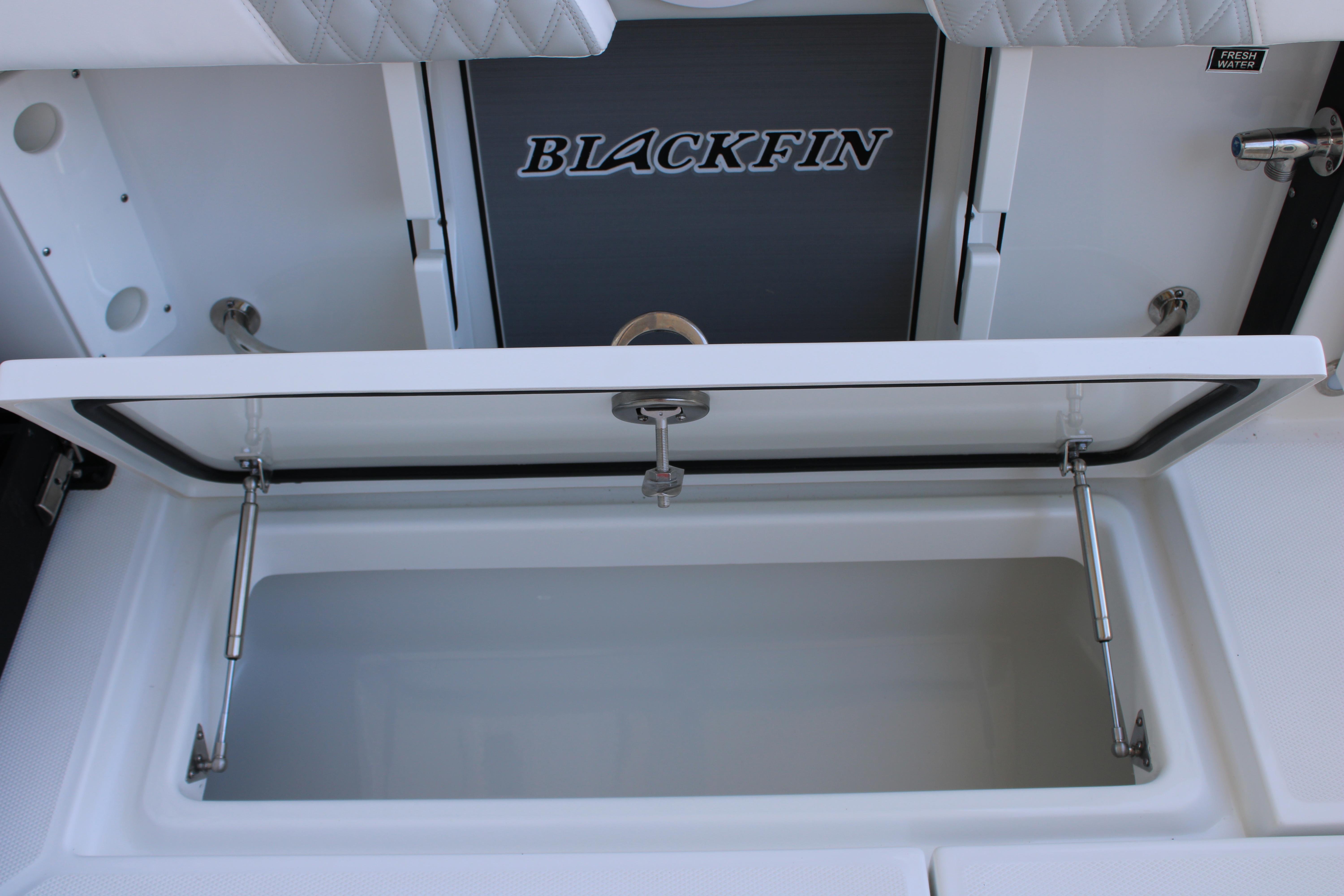Slide: The Image of 2023 Blackfin 252 DC boat storage compartment with open lid. - 16