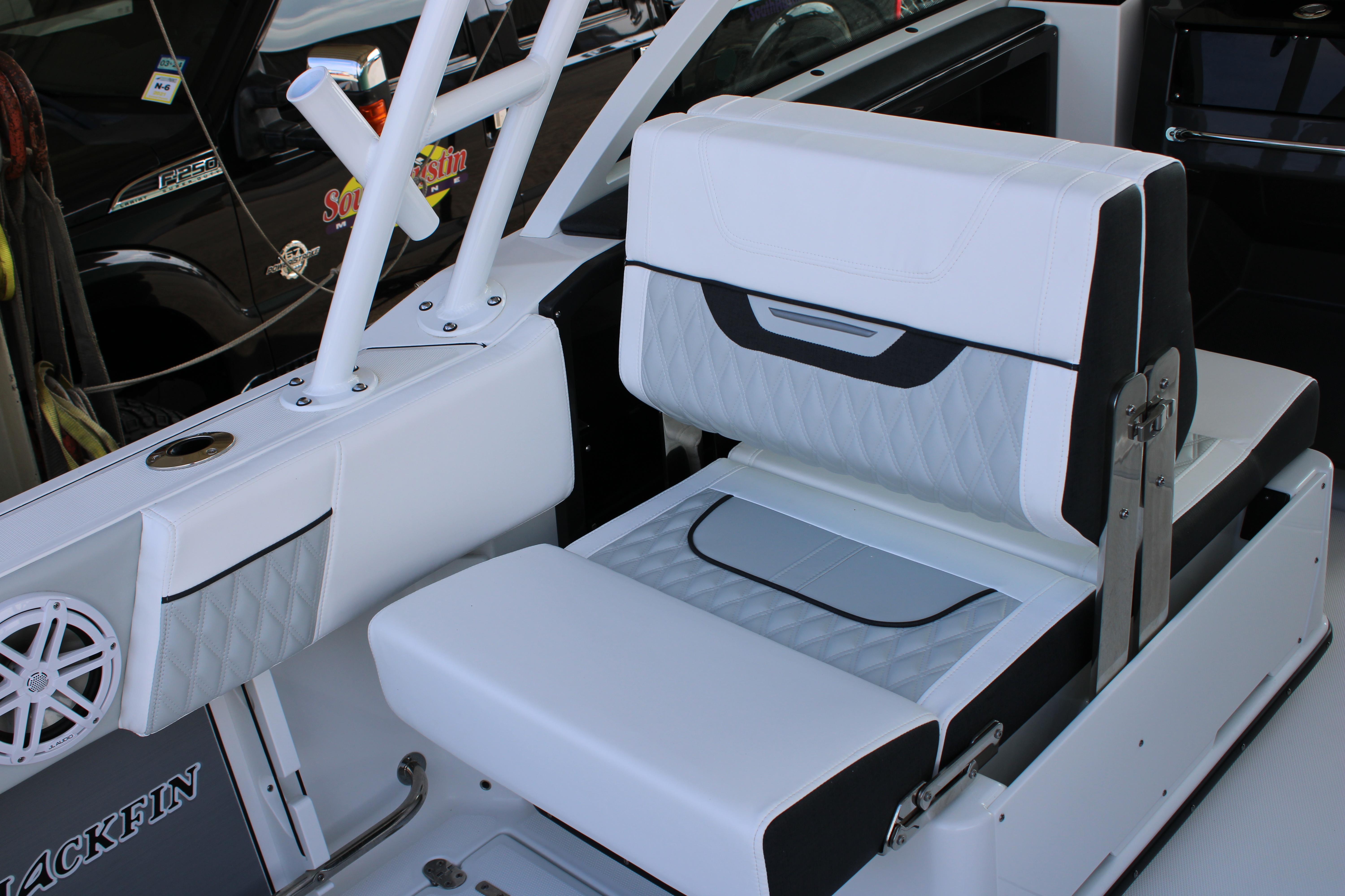 Slide: The Image of 2023 Blackfin 252 DC boat interior seating with white and gray upholstery. - 17