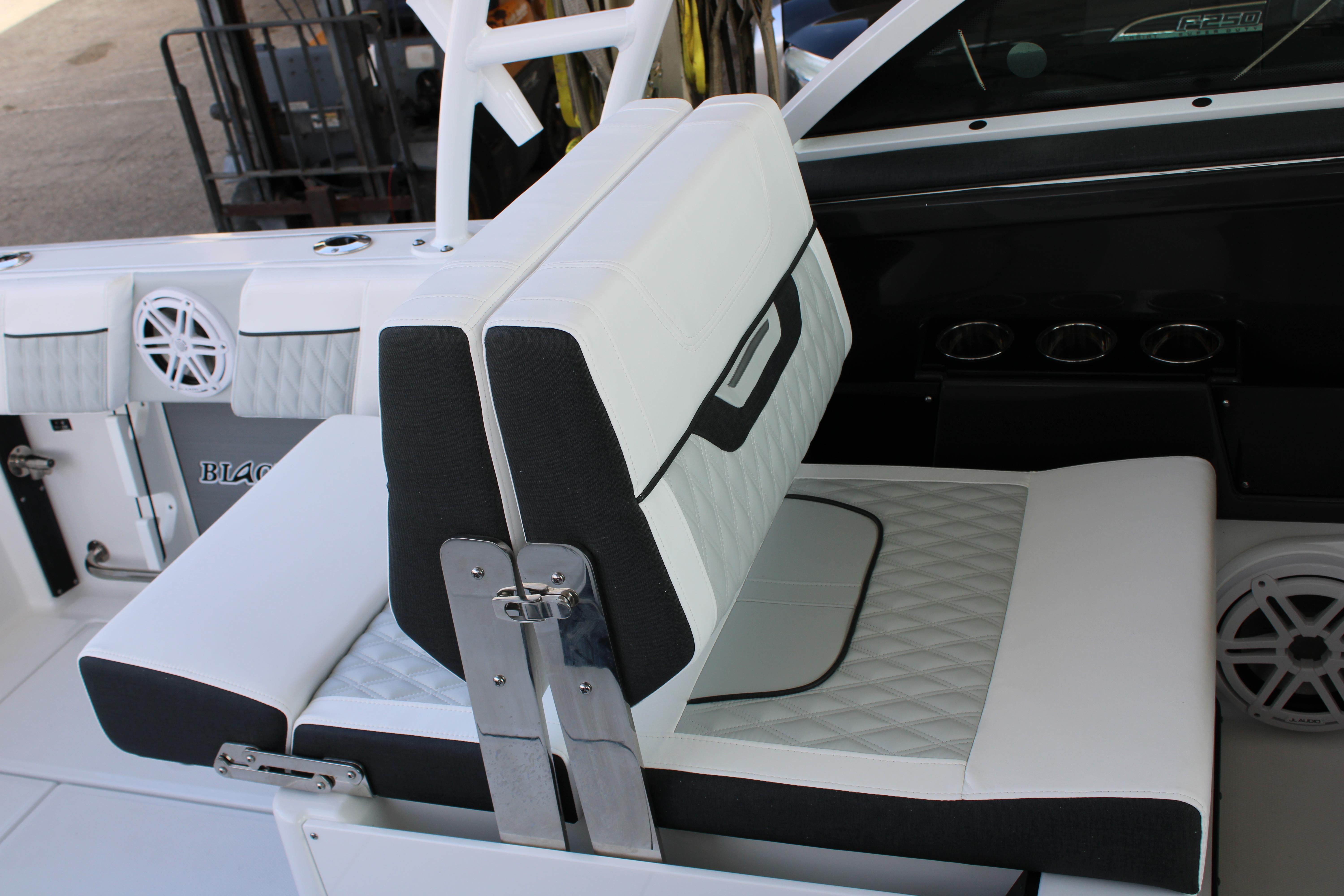 Slide: The Image of 2023 Blackfin 252 DC boat interior seating with white and black upholstery. - 18