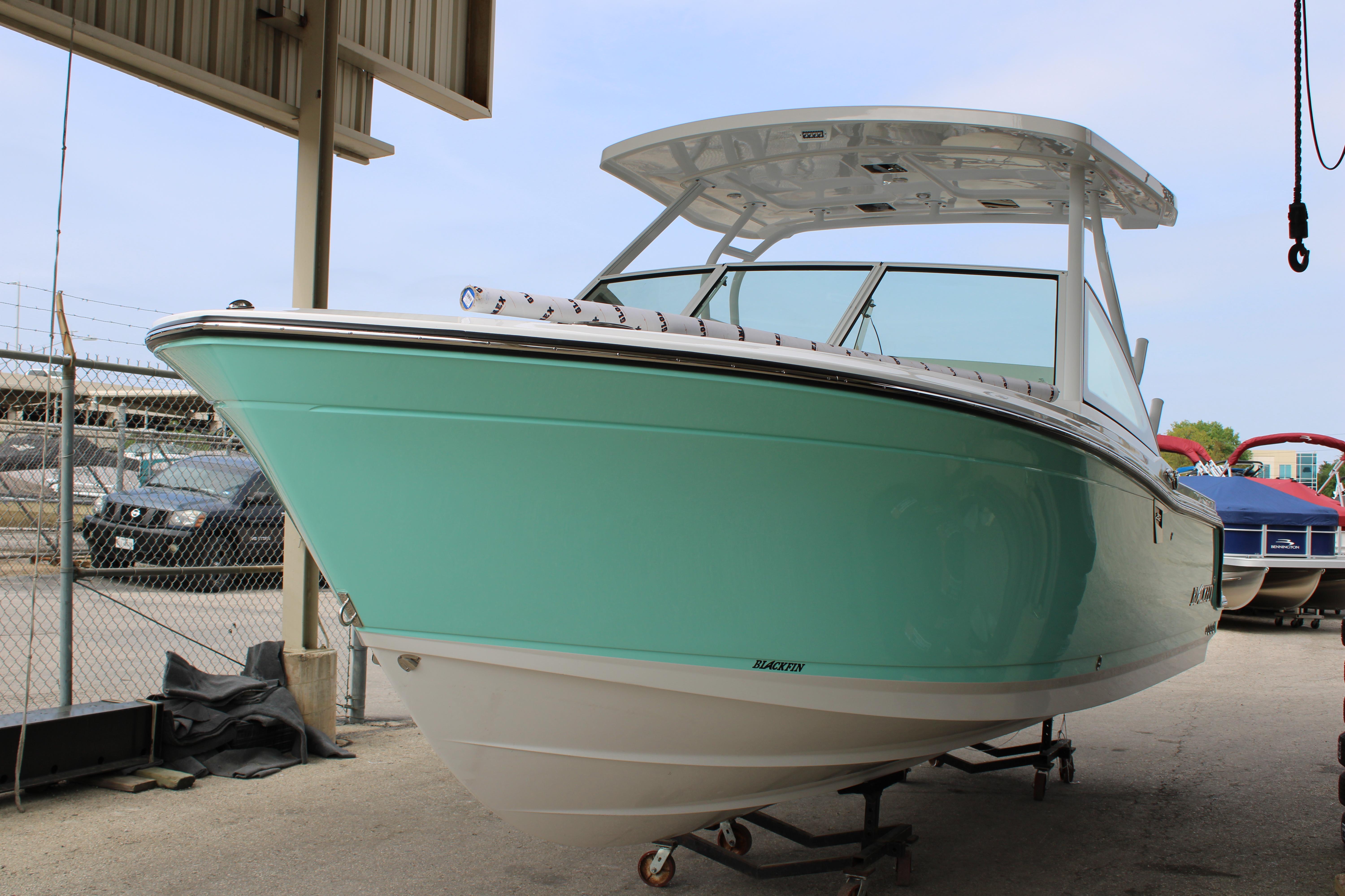 Slide: The Image of 2023 Blackfin 252 DC boat in mint green, docked and ready for adventure. - 2