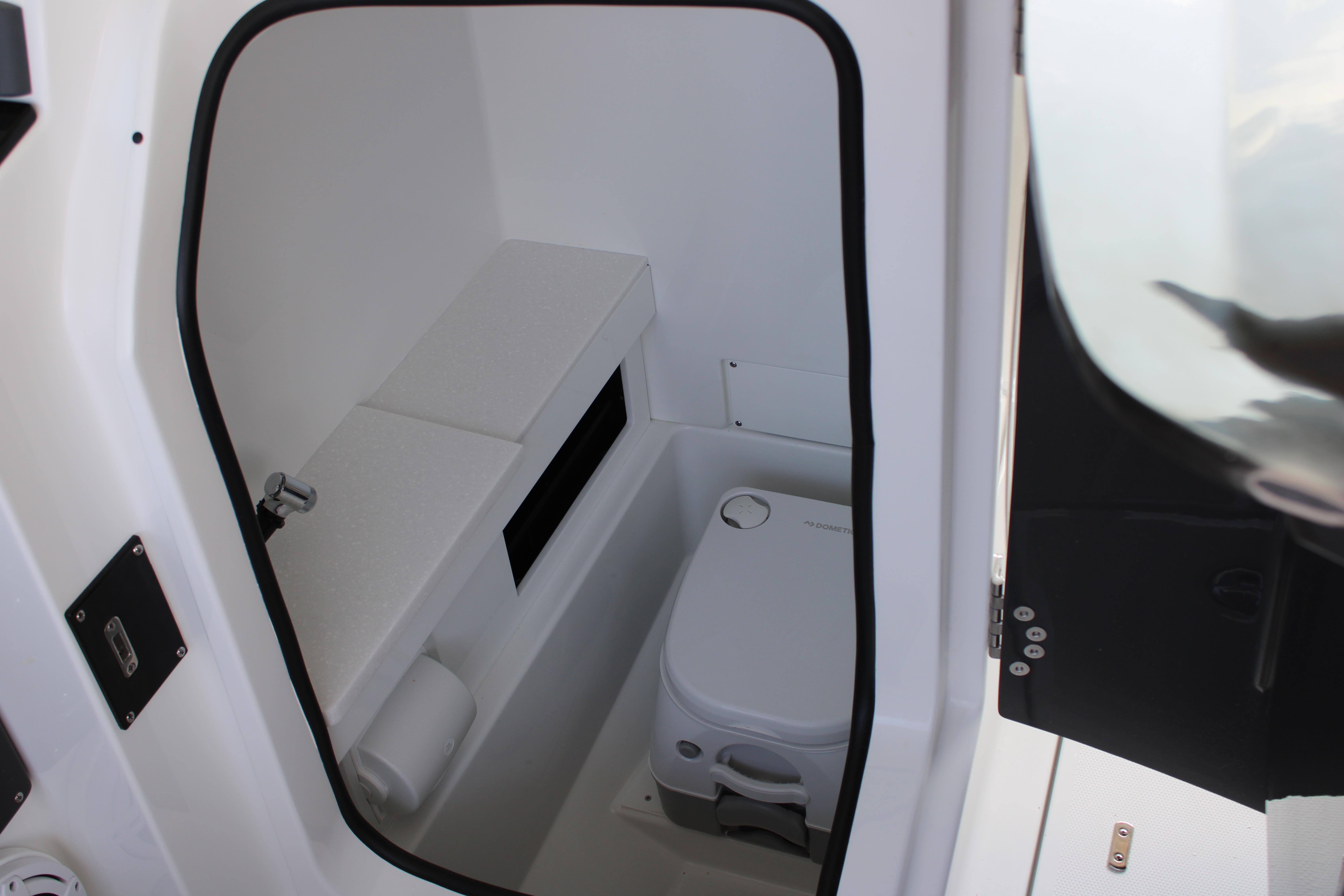 Slide: The Image of 2023 Blackfin 252 DC boat interior with compact marine toilet. - 20