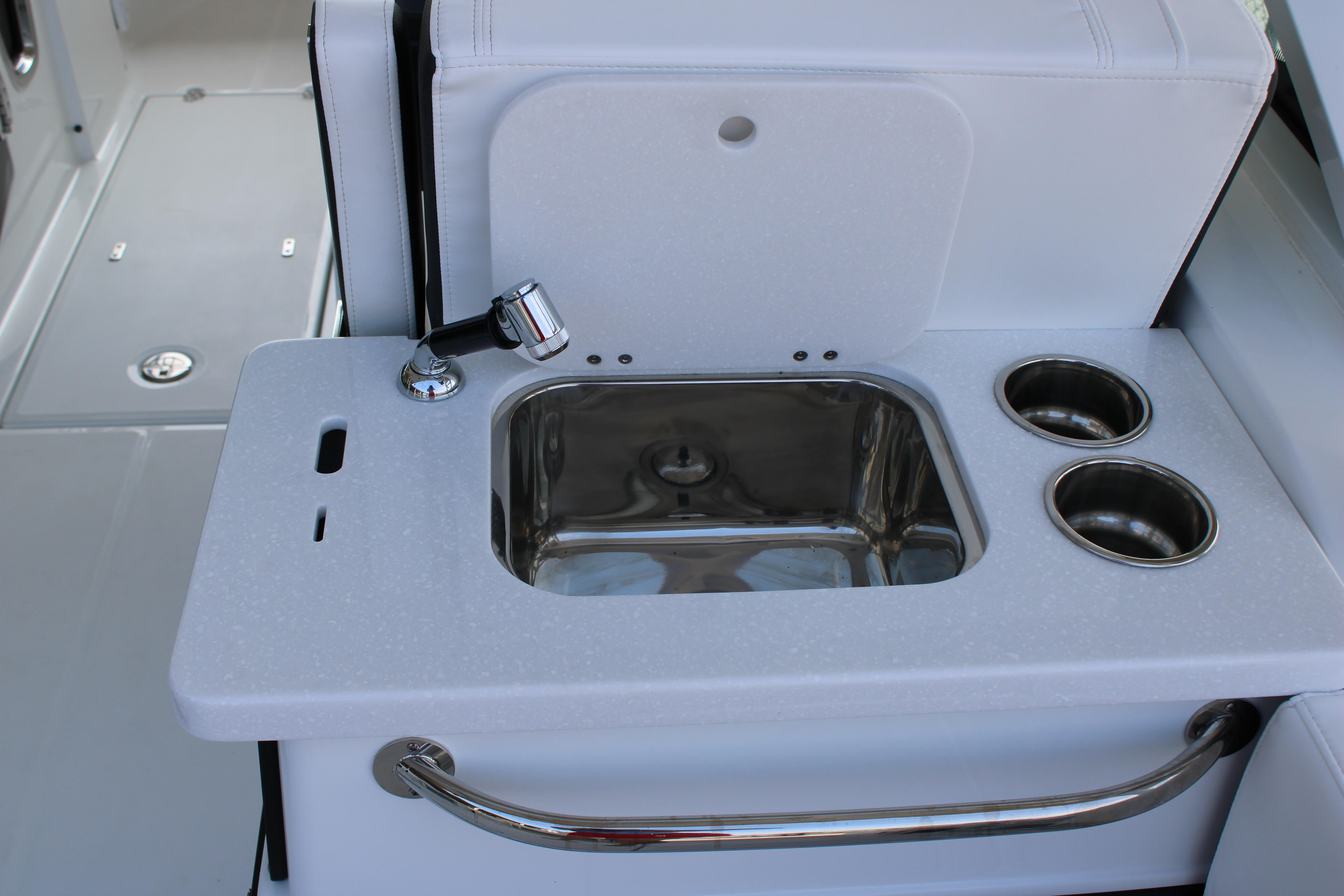 Slide: The Image of 2023 Blackfin 252 DC boat sink and cup holders in cockpit area. - 22