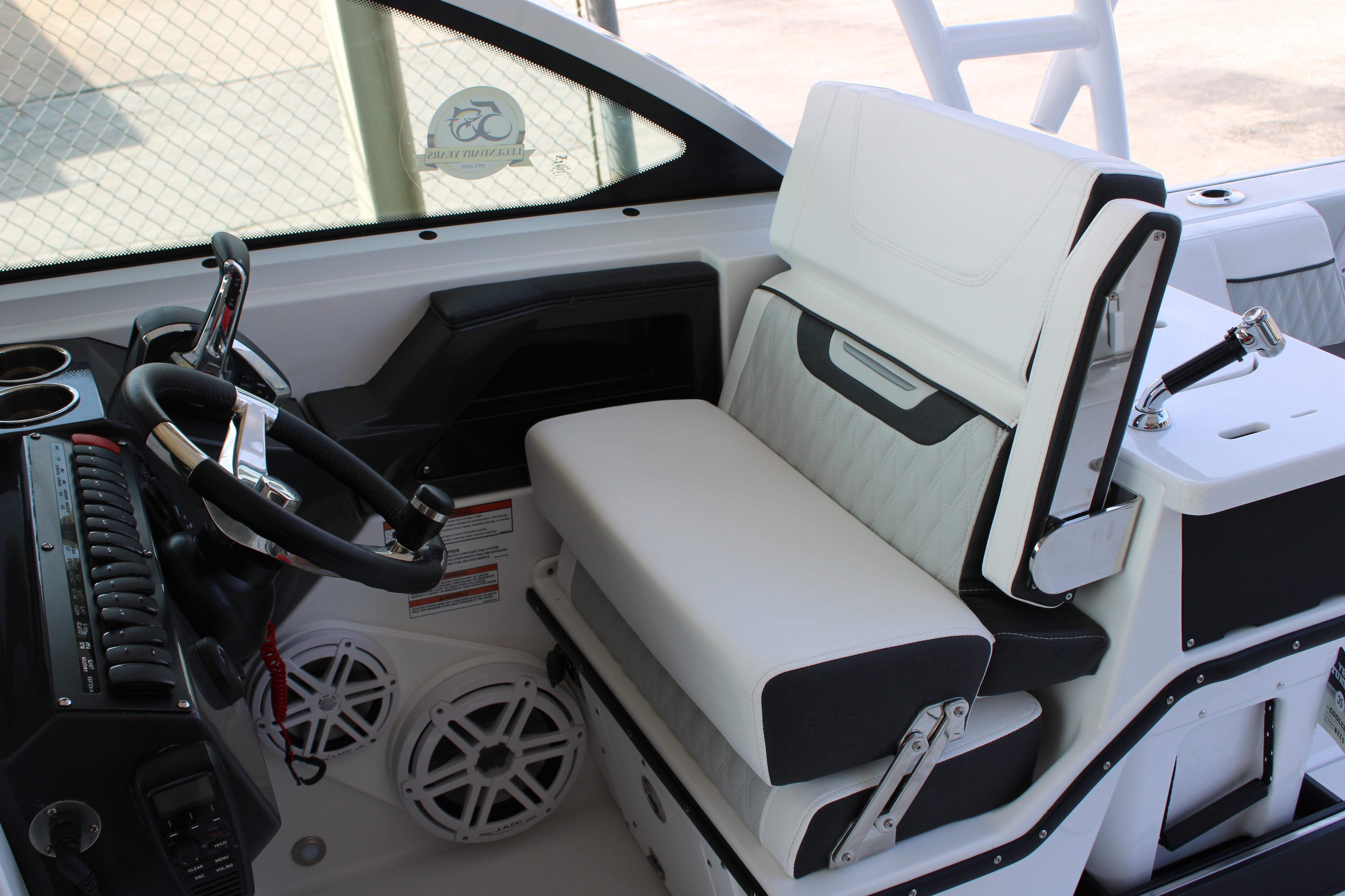 Slide: The Image of 2023 Blackfin 252 DC boat cockpit with steering wheel and seating. - 25