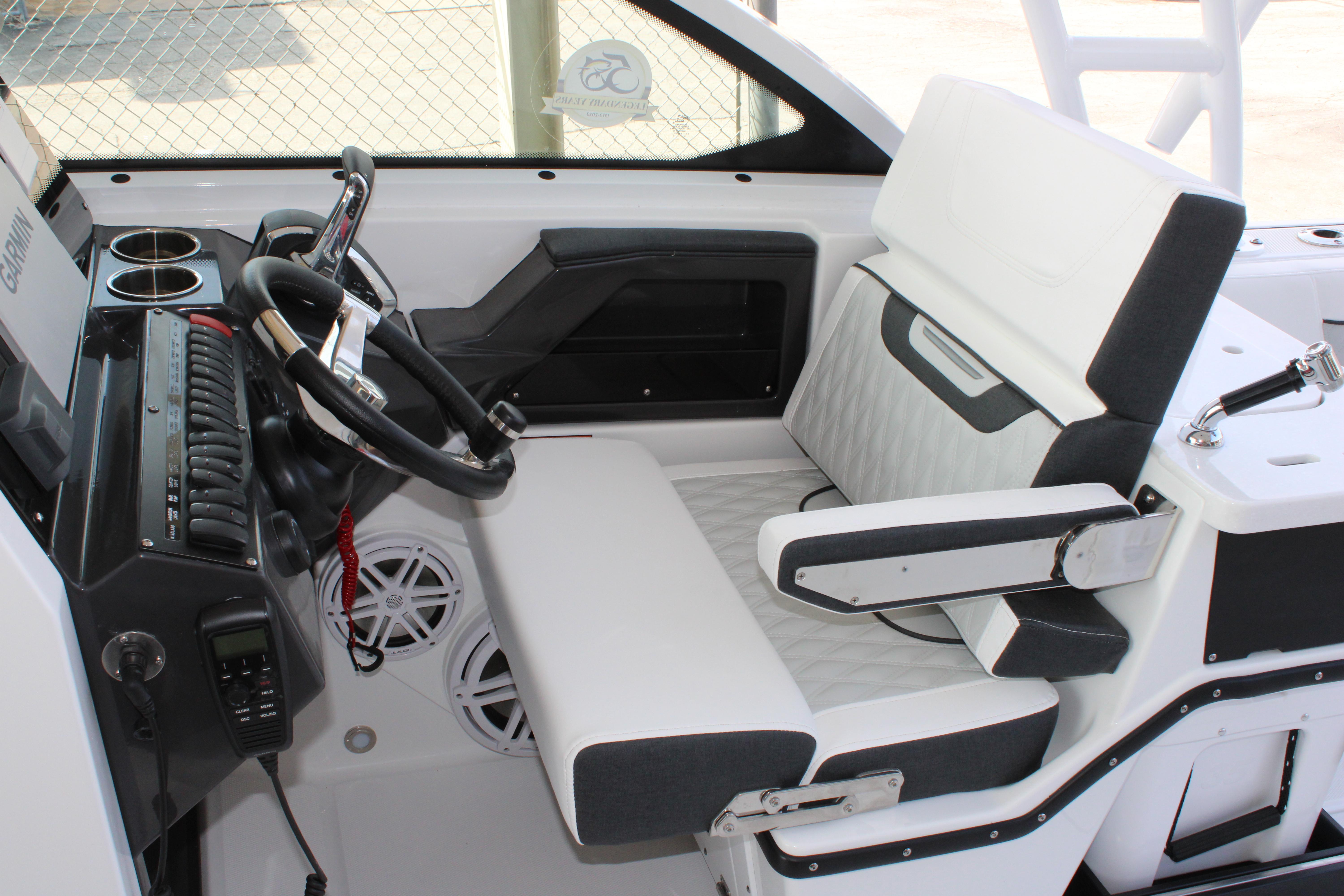 Slide: The Image of 2023 Blackfin 252 DC helm with steering wheel, controls, and cushioned seating. - 26