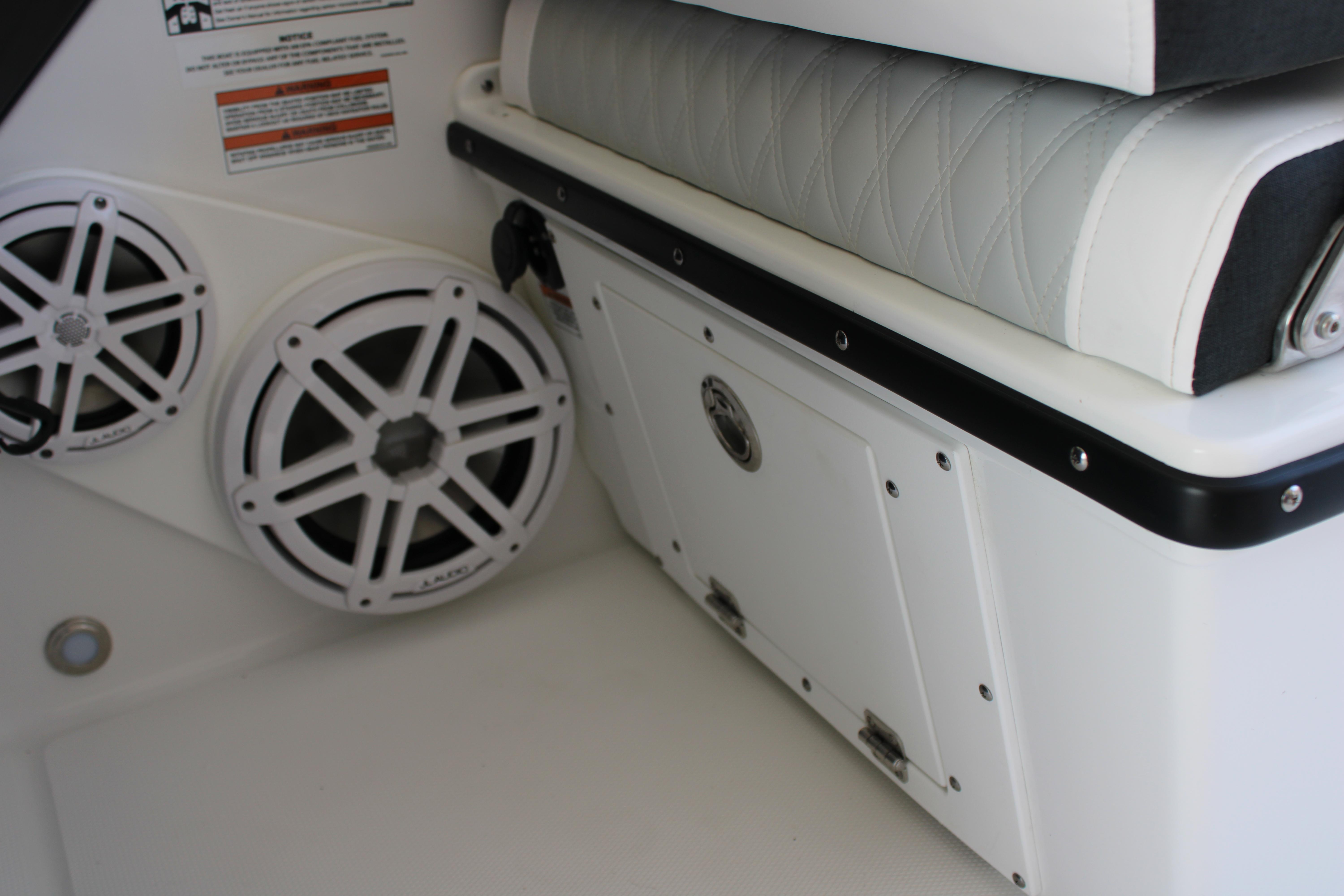 Slide: The Image of Interior of 2023 Blackfin 252 DC boat with speakers and storage compartment. - 28