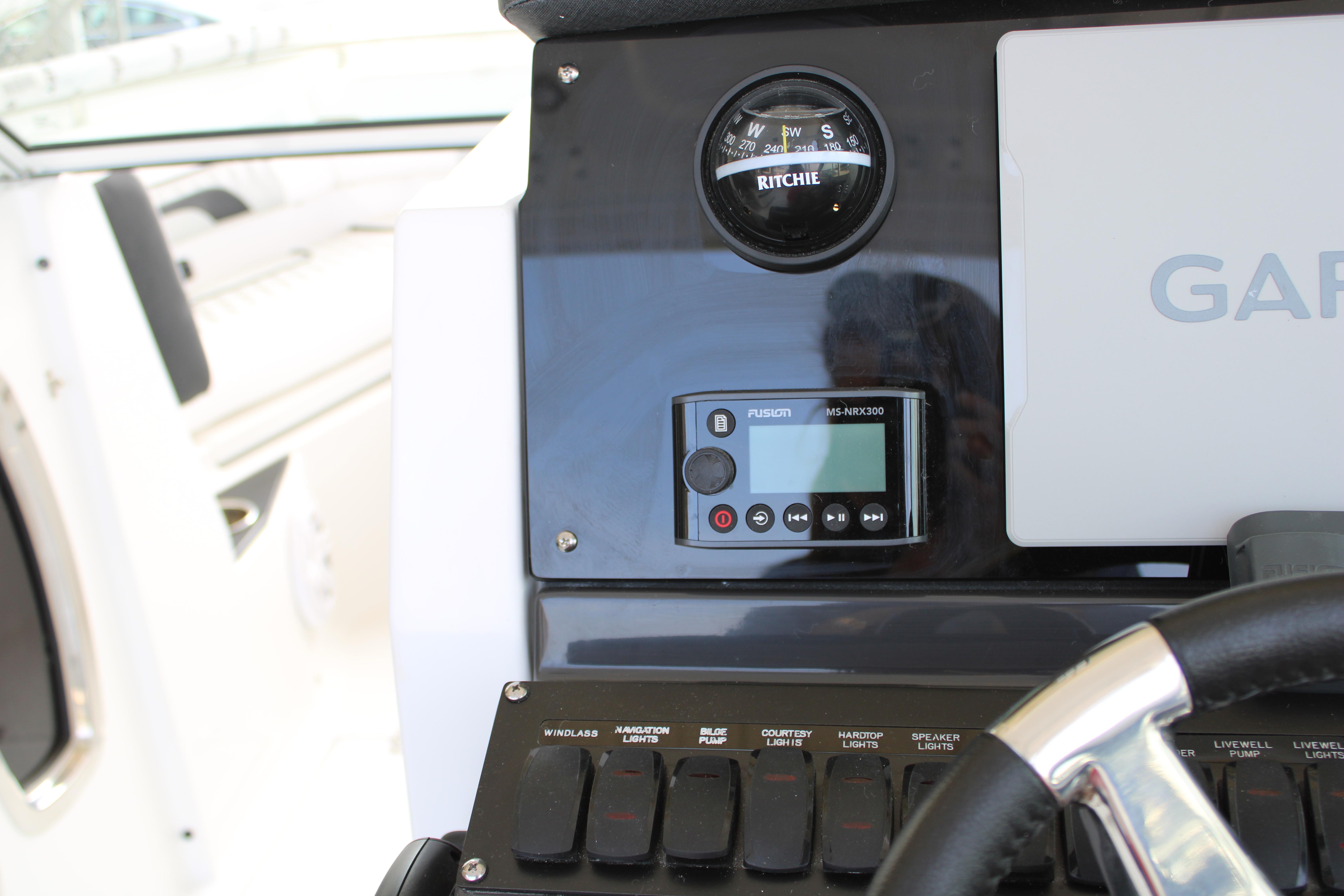 Slide: The Image of Control panel of 2023 Blackfin 252 DC boat with compass, Fusion MS-NRX300, and Garmin system. - 30