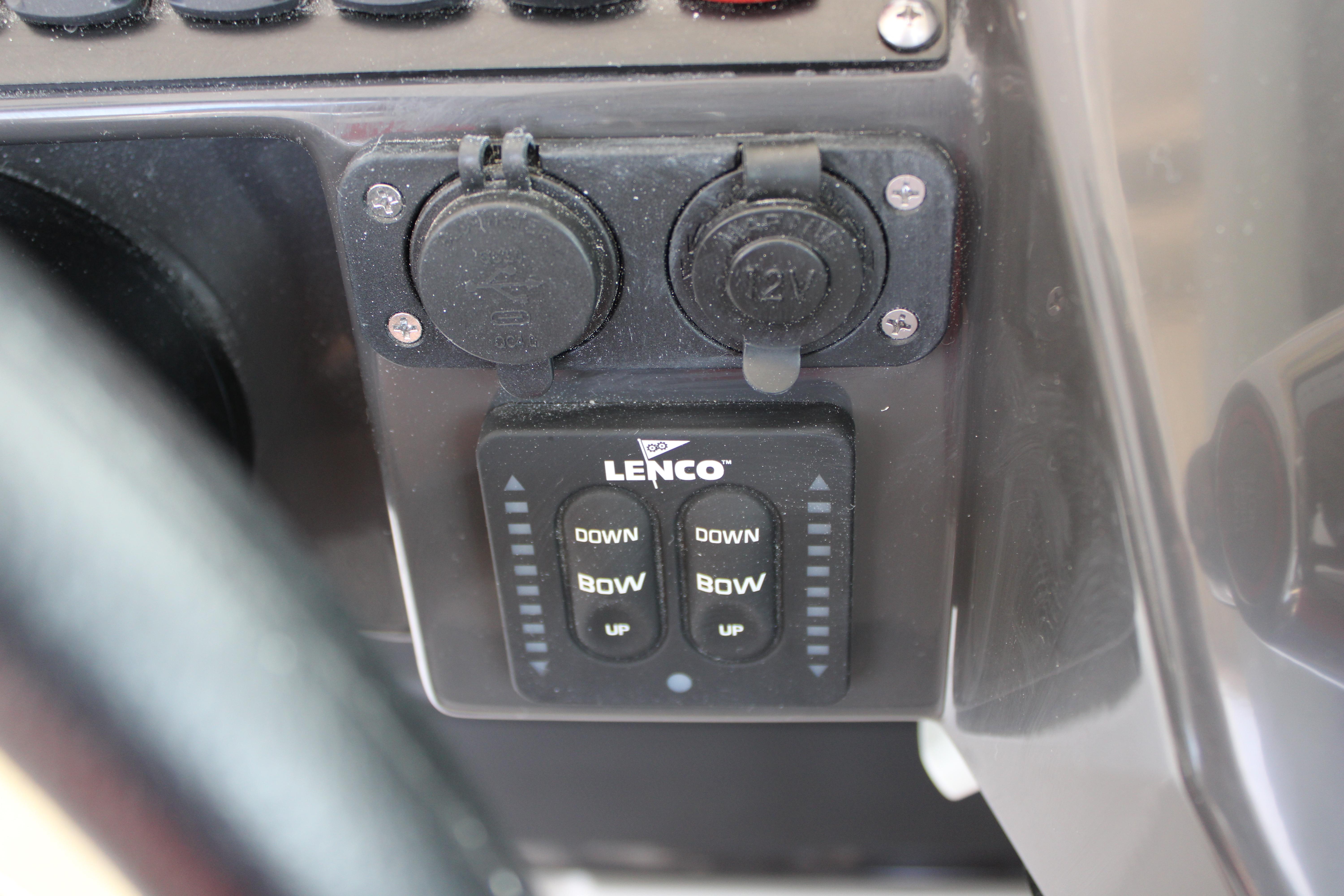 Slide: The Image of Close-up of Lenco trim tab controls and 12V outlets on a 2023 Blackfin 252 DC boat. - 31