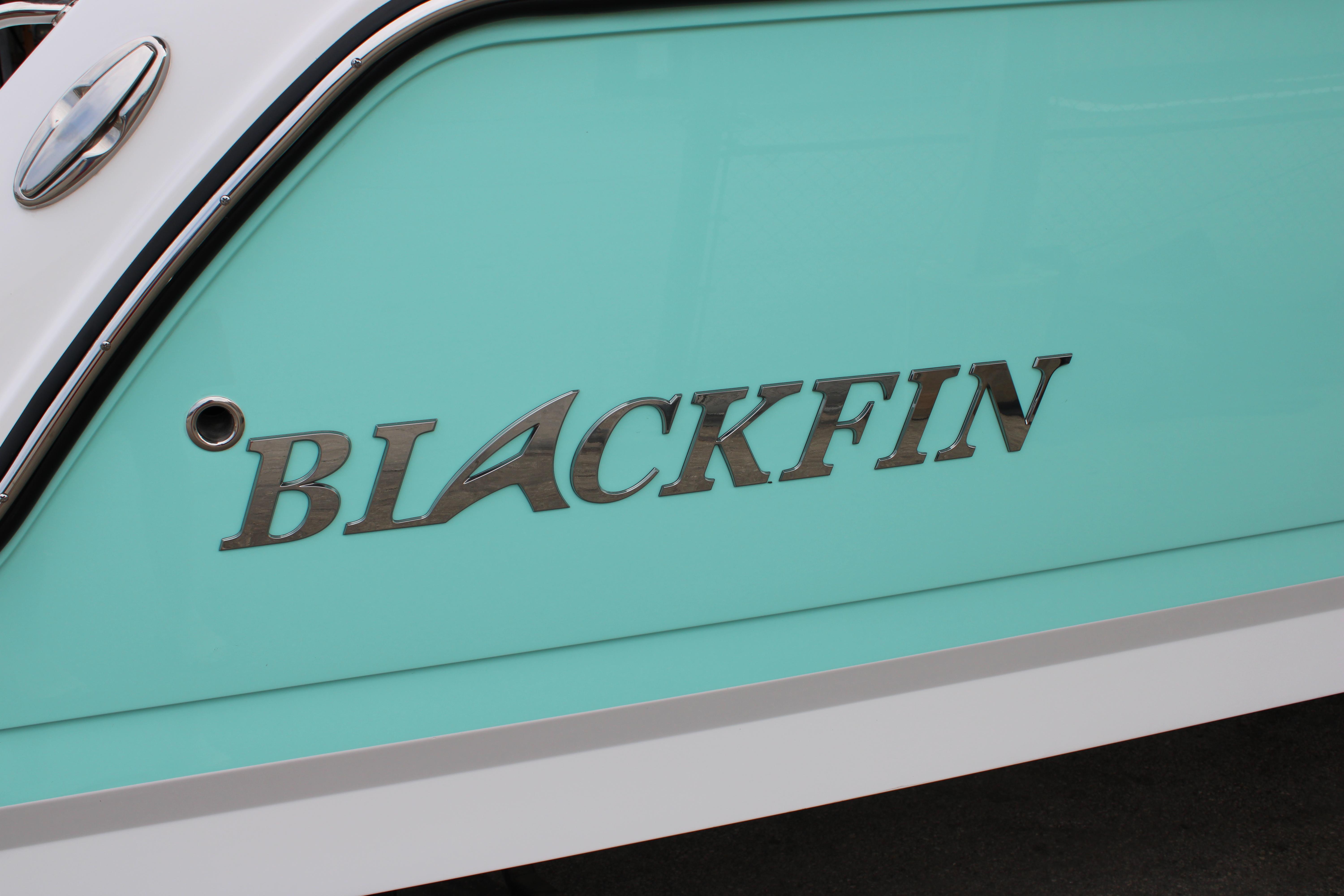 Slide: The Image of Close-up of 2023 Blackfin 252 DC boat logo on turquoise hull. - 4