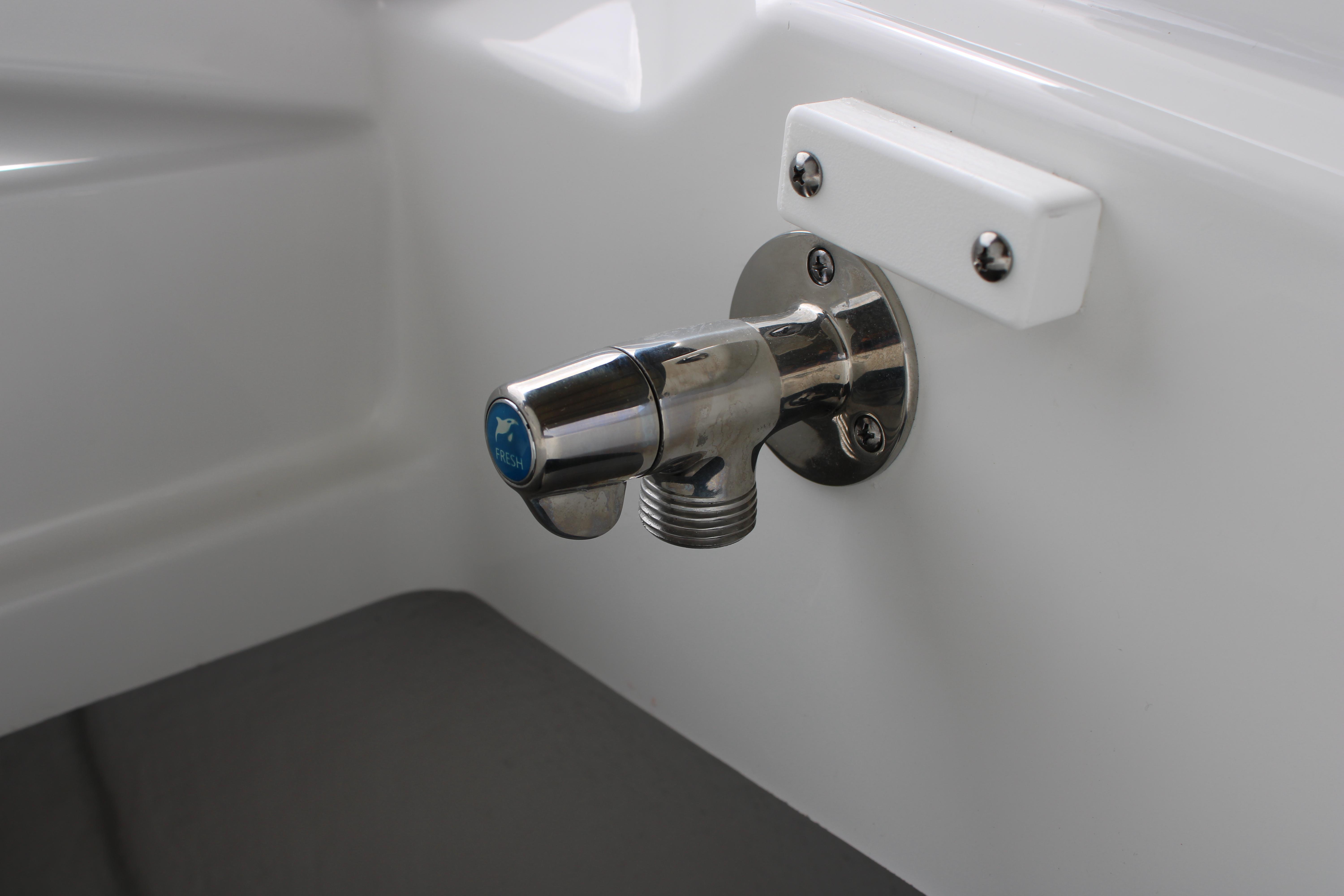 Slide: The Image of Close-up of a fresh water faucet on a 2023 Blackfin 252 DC boat. - 44