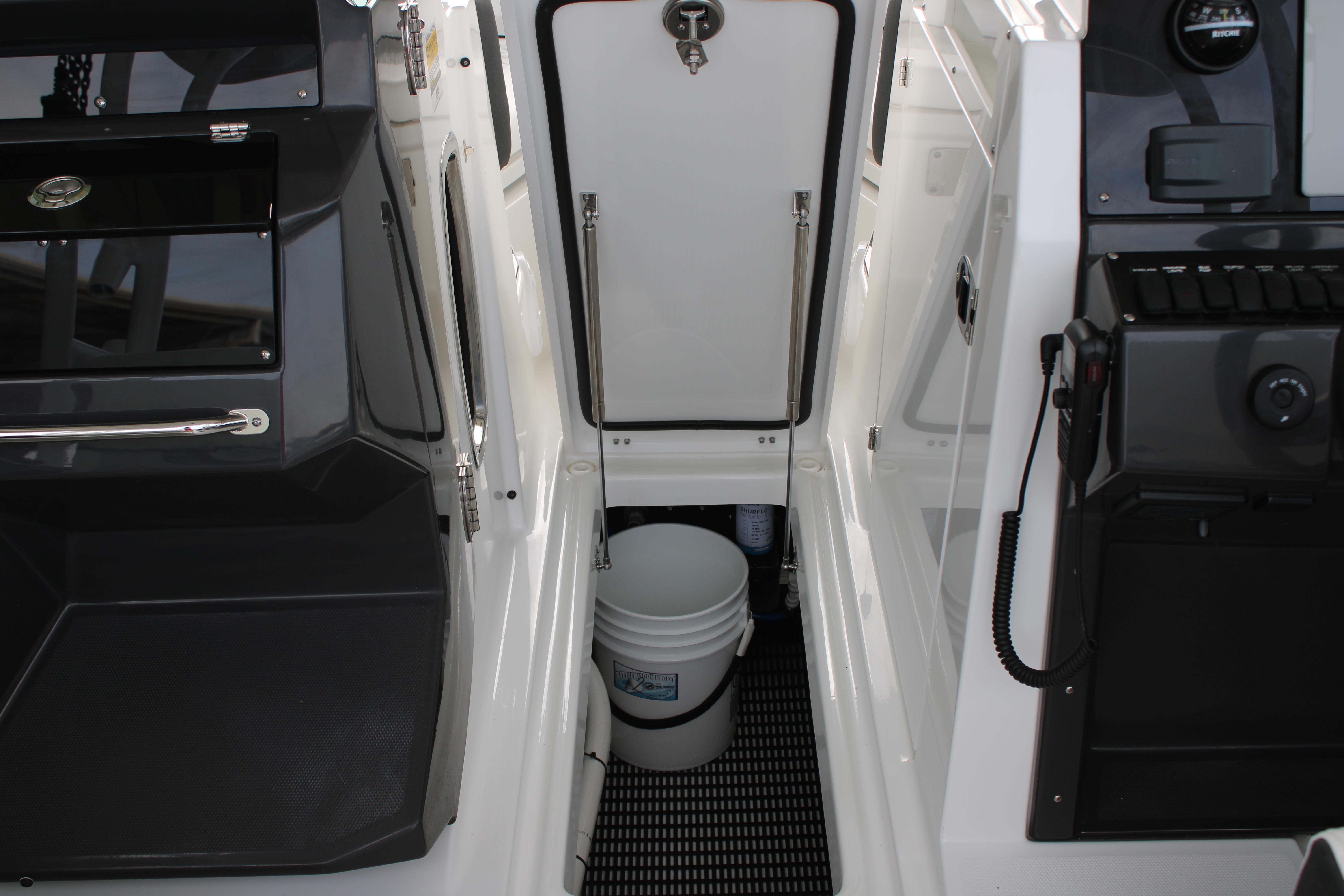 Slide: The Image of Interior storage compartment of 2023 Blackfin 252 DC boat with bucket and equipment. - 45