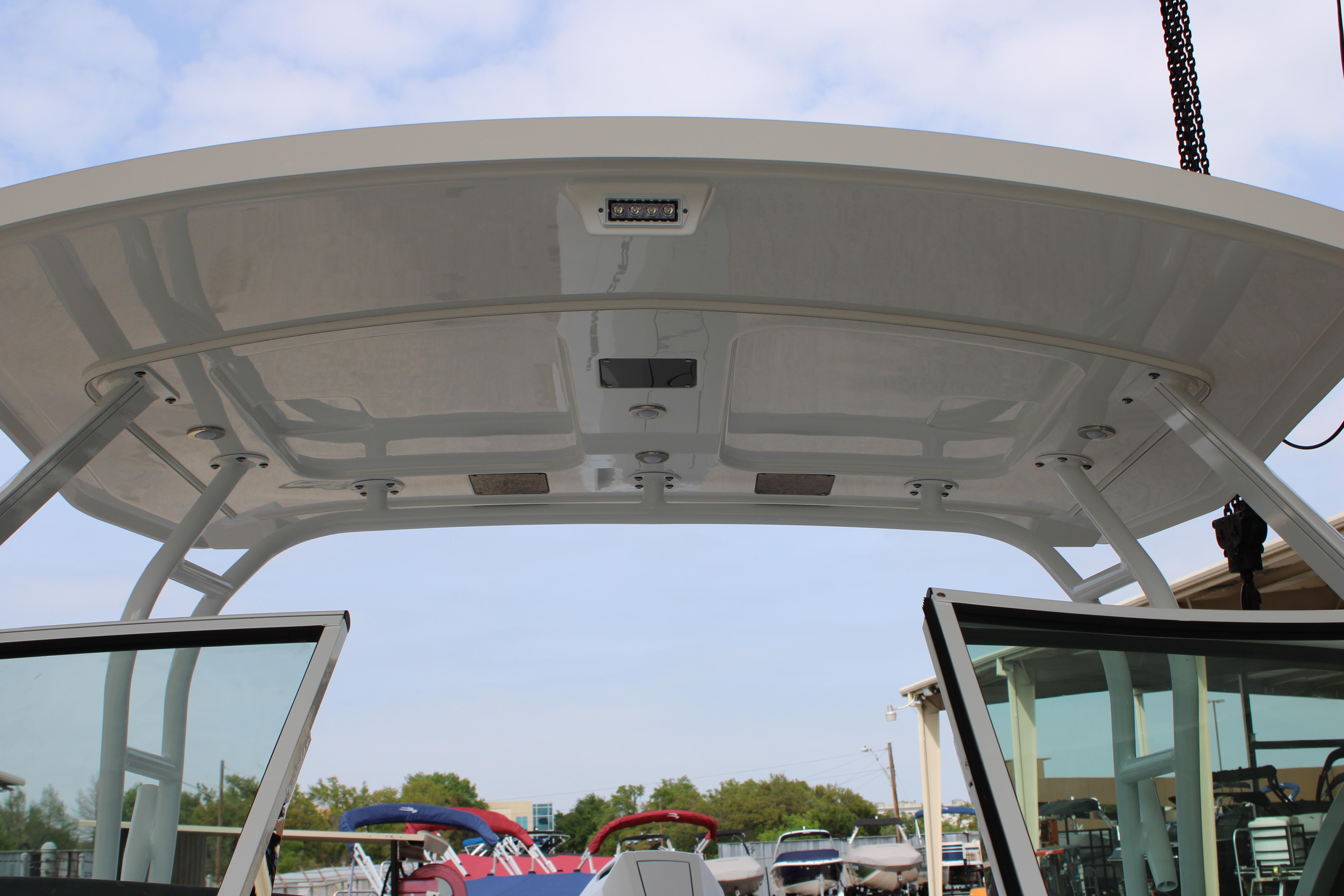 Slide: The Image of 2023 Blackfin 252 DC boat hardtop and windshield at marina. - 46