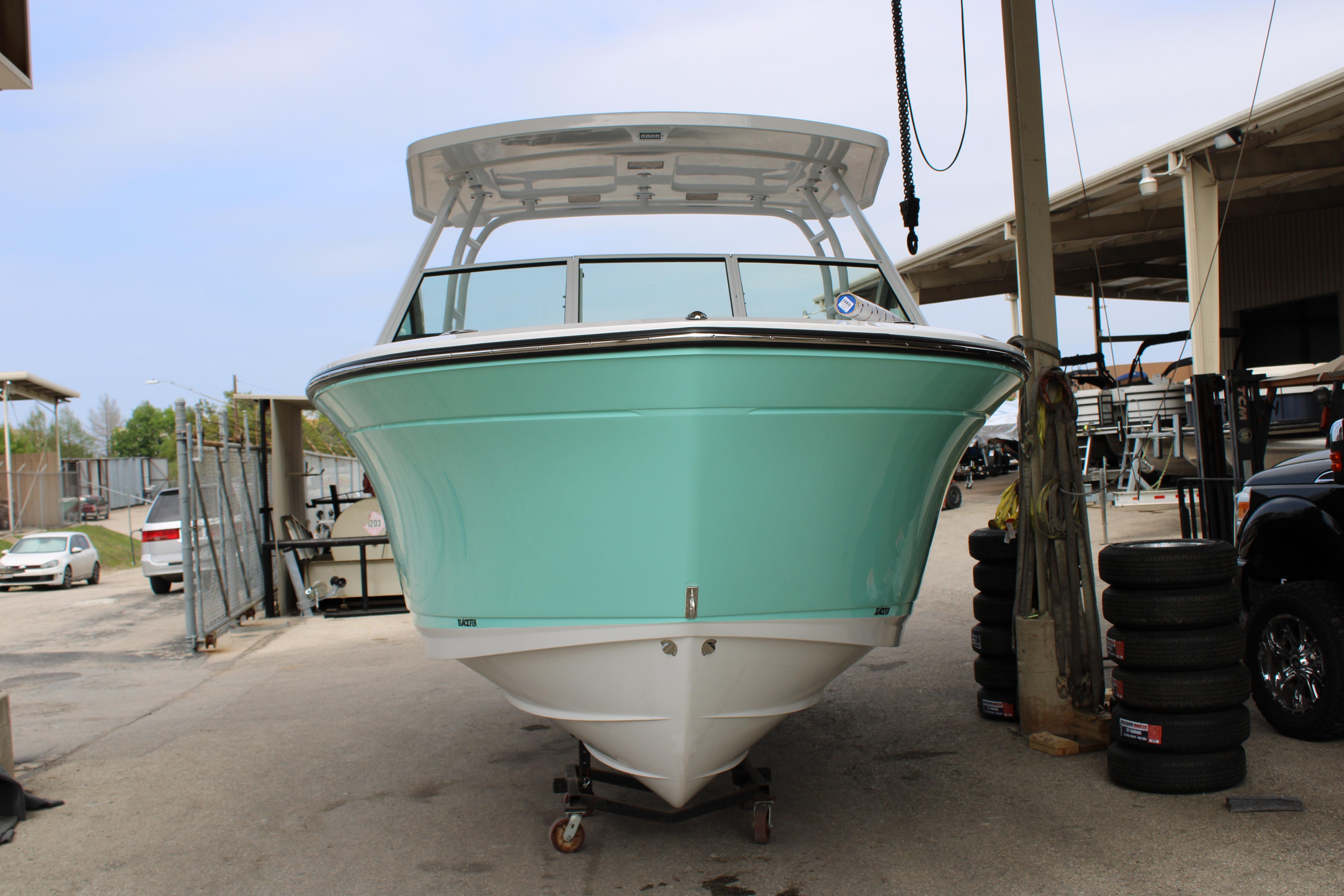 Slide: The Image of 2023 Blackfin 252 DC boat in a marina, front view. - 47