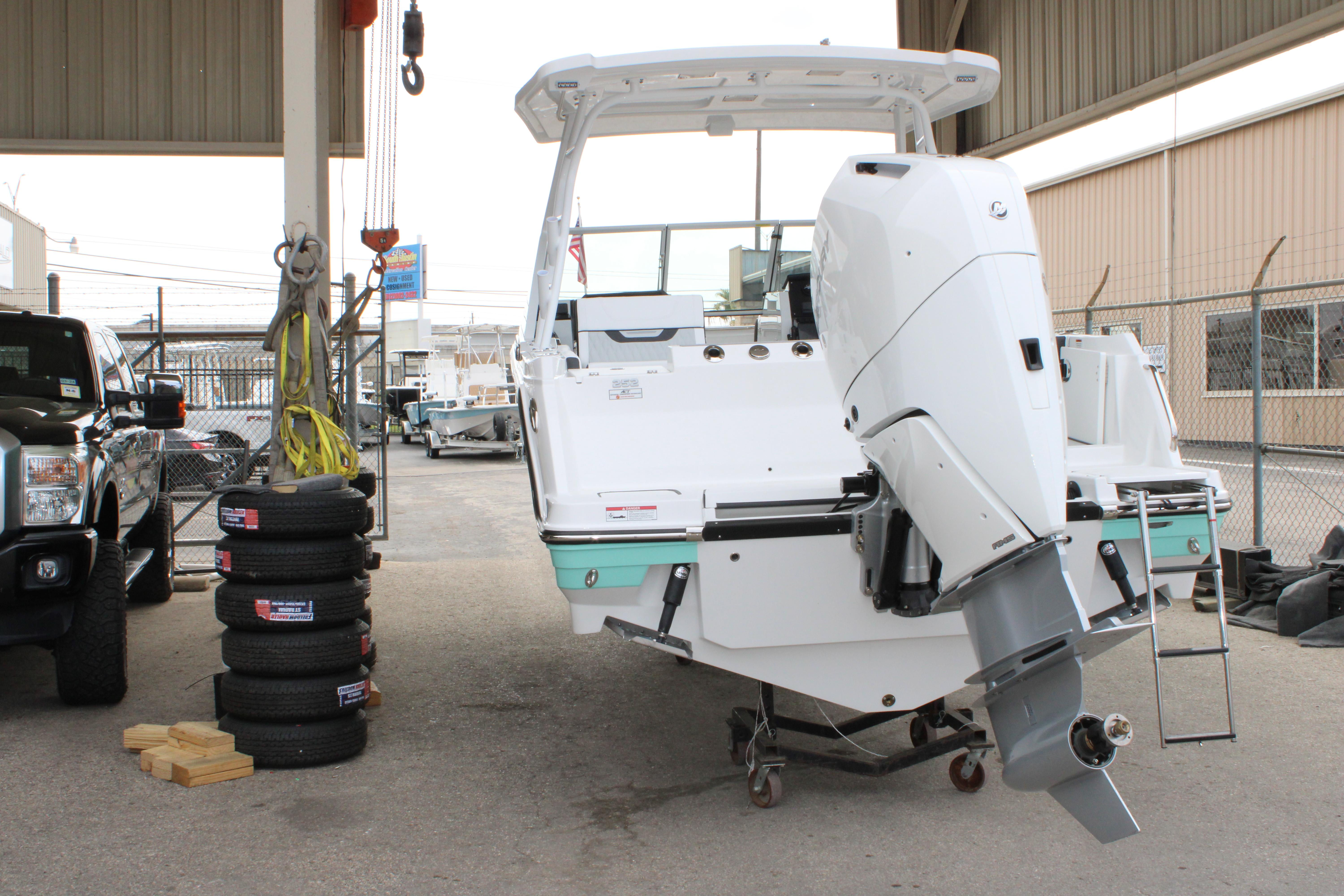 Slide: The Image of 2023 Blackfin 252 DC boat with outboard motor in a storage facility. - 49