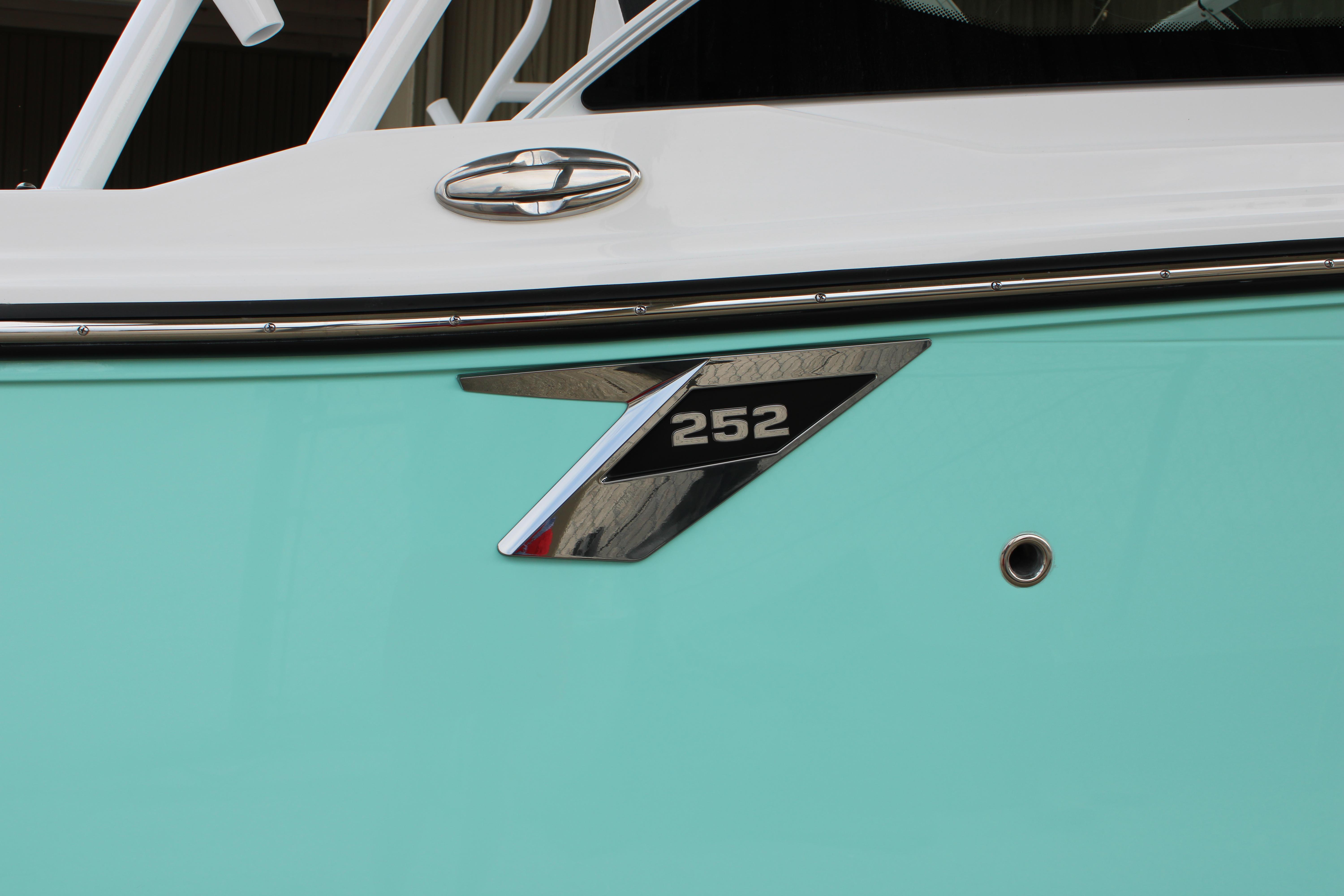 Slide: The Image of Close-up of 2023 Blackfin 252 DC boat exterior with model emblem. - 5