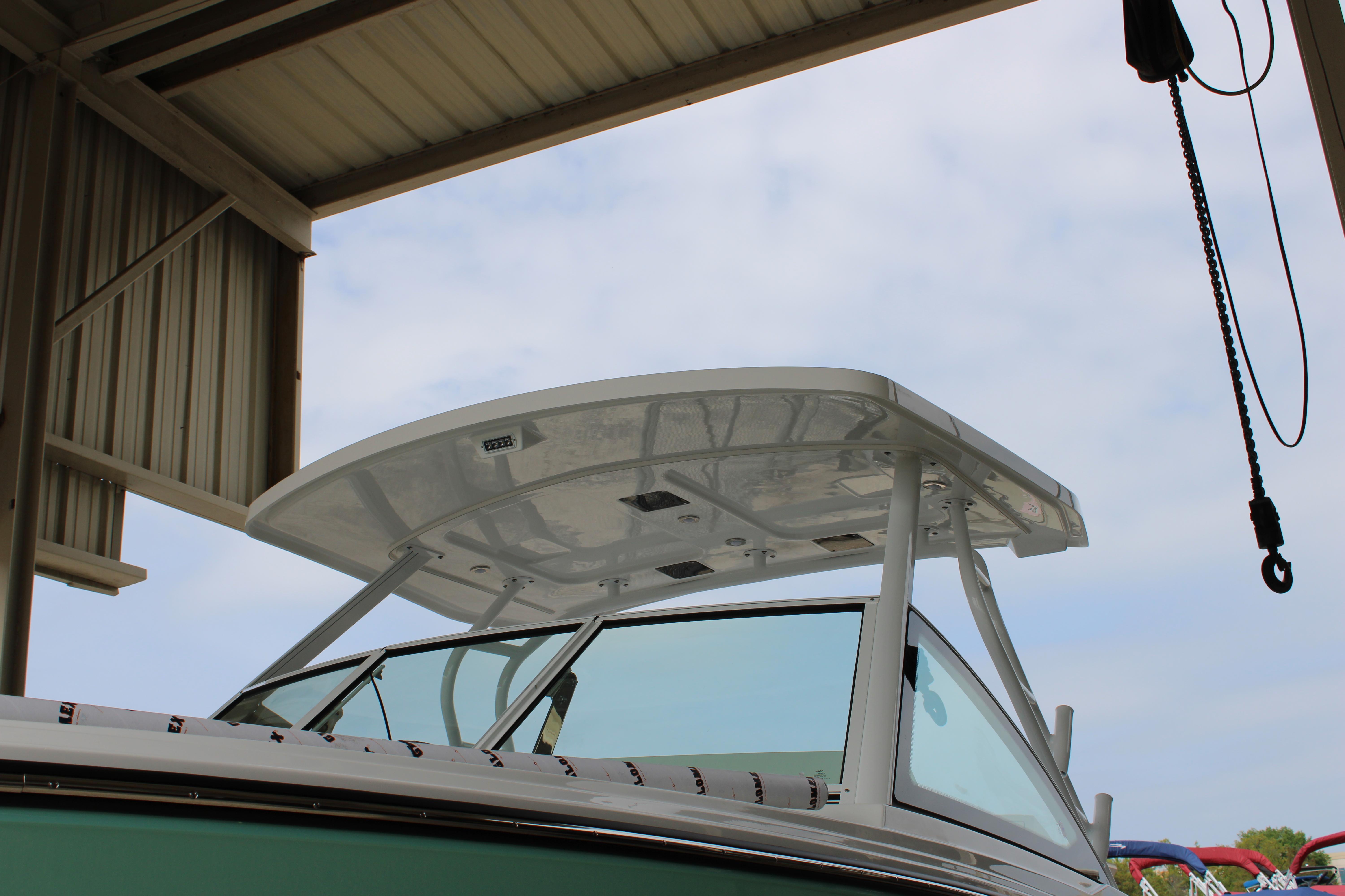 Slide: The Image of 2023 Blackfin 252 DC boat under a metal canopy. - 7