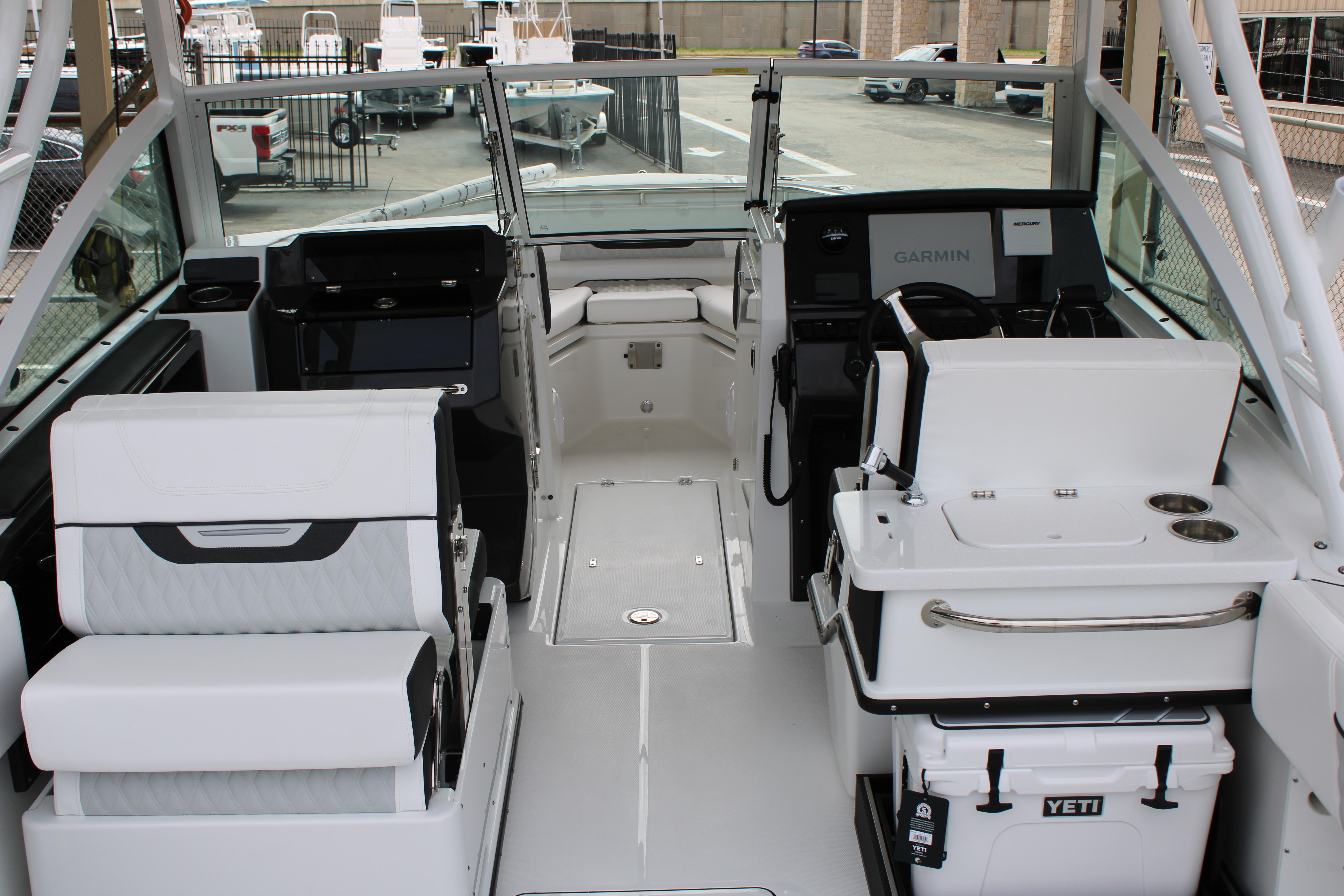 Slide: The Image of 2023 Blackfin 252 DC boat interior with modern seating, Garmin navigation, and Yeti cooler. - 9