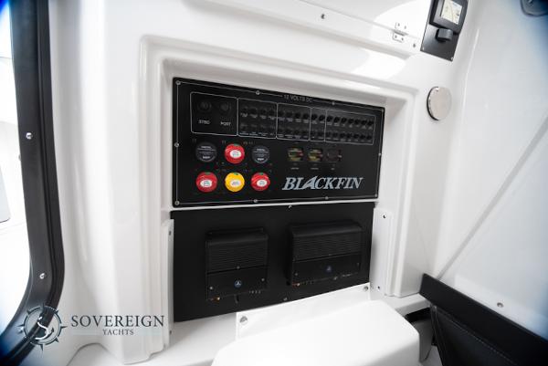 Slide: The Image of 2024 Blackfin 272 CC control panel with switches and gauges, Sovereign Yachts branding. - 26