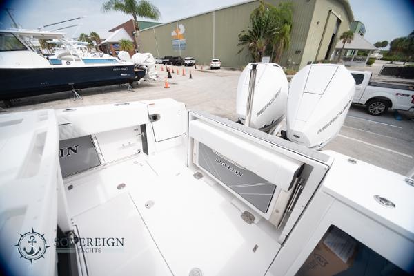 Slide: The Image of 2024 Blackfin 272 CC boat with twin Mercury engines at a marina. - 30