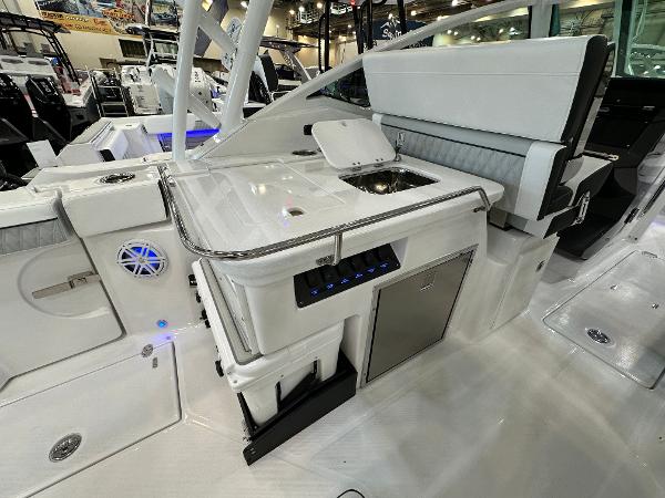 Slide: The Image of 2024 Blackfin 302 DC boat interior with sleek kitchen and seating area. - 12