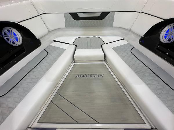 Slide: The Image of 2024 Blackfin 302 DC boat interior with sleek seating and modern design. - 23
