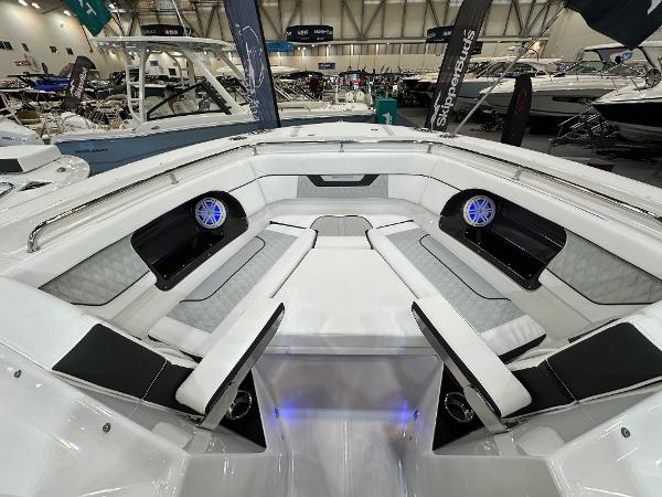Slide: The Image of 2024 Blackfin 302 DC boat interior with modern seating and speakers at a boat show. - 24