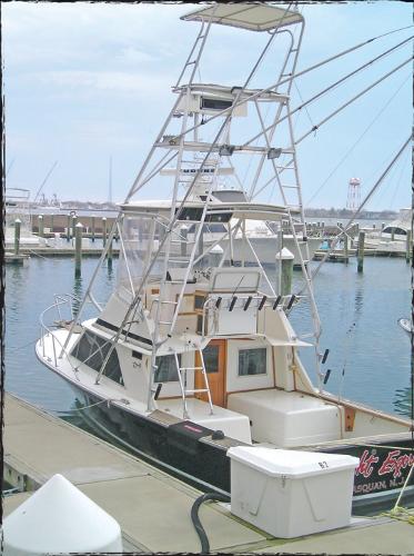 Slide: The Image of 1980 Blackfin 32 Flybridge boat docked at a marina. - 1