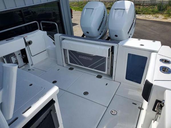Slide: The Image of 2023 Blackfin 332cc boat deck with twin outboard engines. - 11