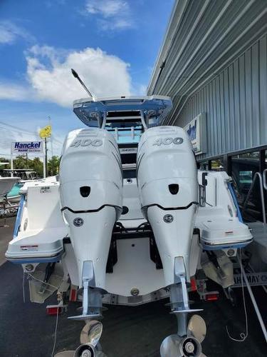 Slide: The Image of 2023 Blackfin 332cc boat with twin 400 horsepower engines at a dealership. - 2
