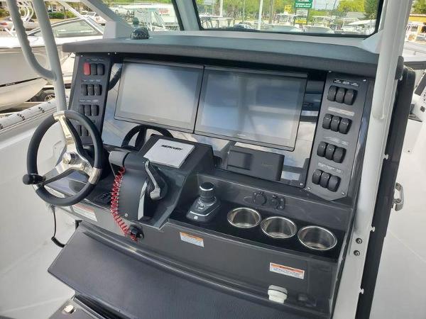 Slide: The Image of 2023 Blackfin 332cc boat dashboard with dual screens and control panel. - 5