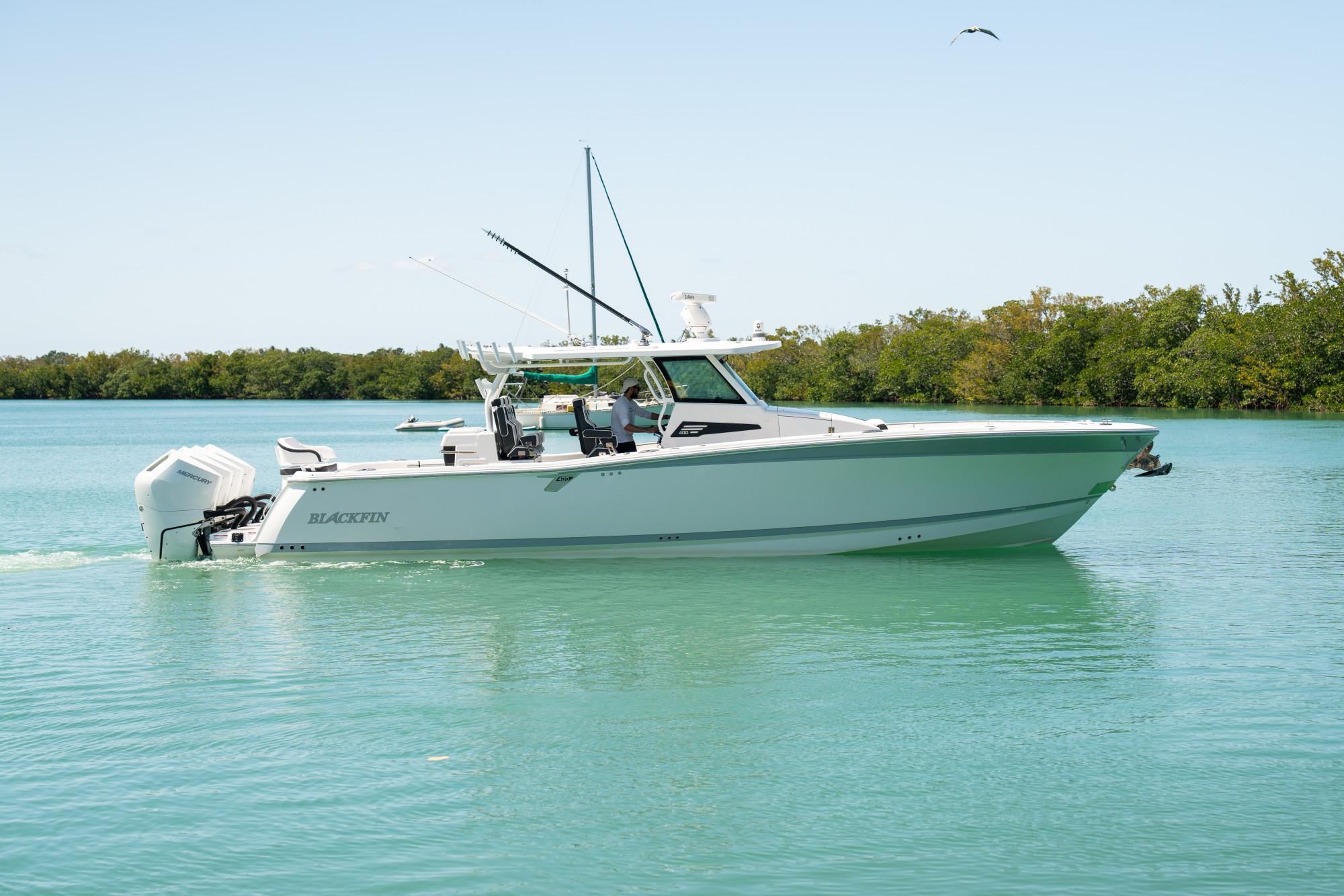 Slide: The Image of 2024 Blackfin 400 CC boat cruising on calm turquoise waters. - 0