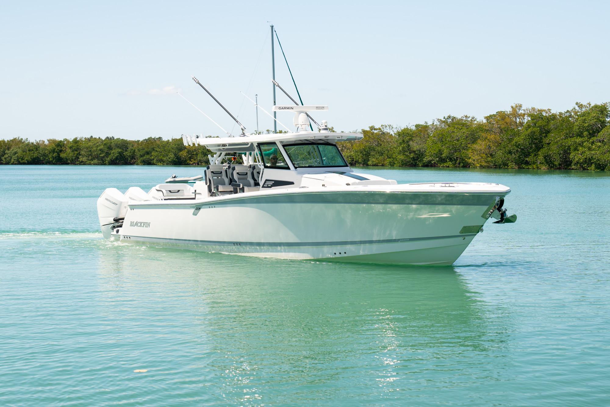 Slide: The Image of 2024 Blackfin 400 CC boat cruising on calm turquoise waters. - 1
