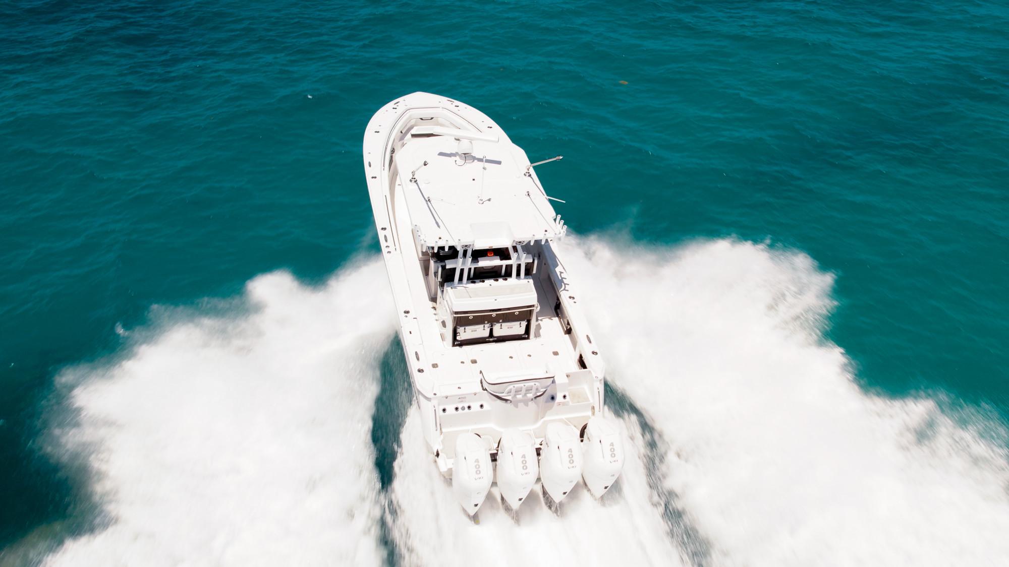 Slide: The Image of 2024 Blackfin 400 CC boat speeding on turquoise ocean waters. - 10