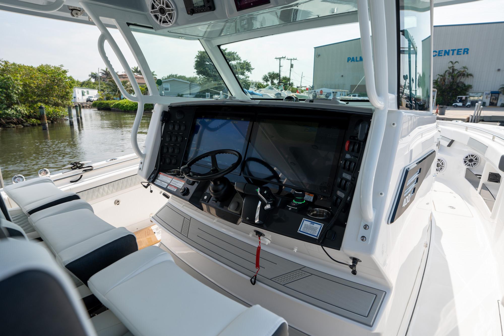 Slide: The Image of 2024 Blackfin 400 CC boat cockpit with modern controls and seating. - 17
