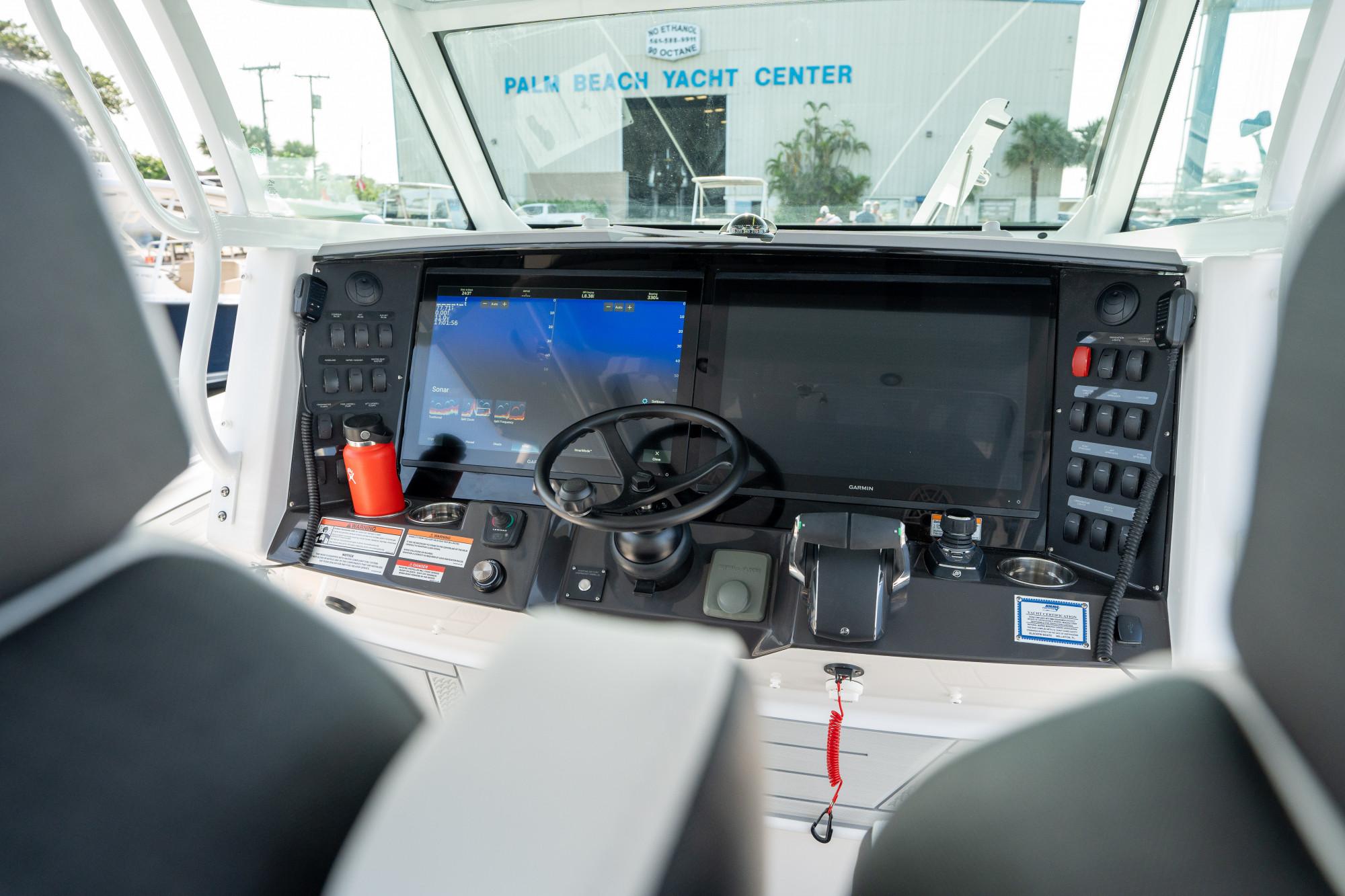 Slide: The Image of 2024 Blackfin 400 CC boat dashboard with advanced navigation system and controls. - 18