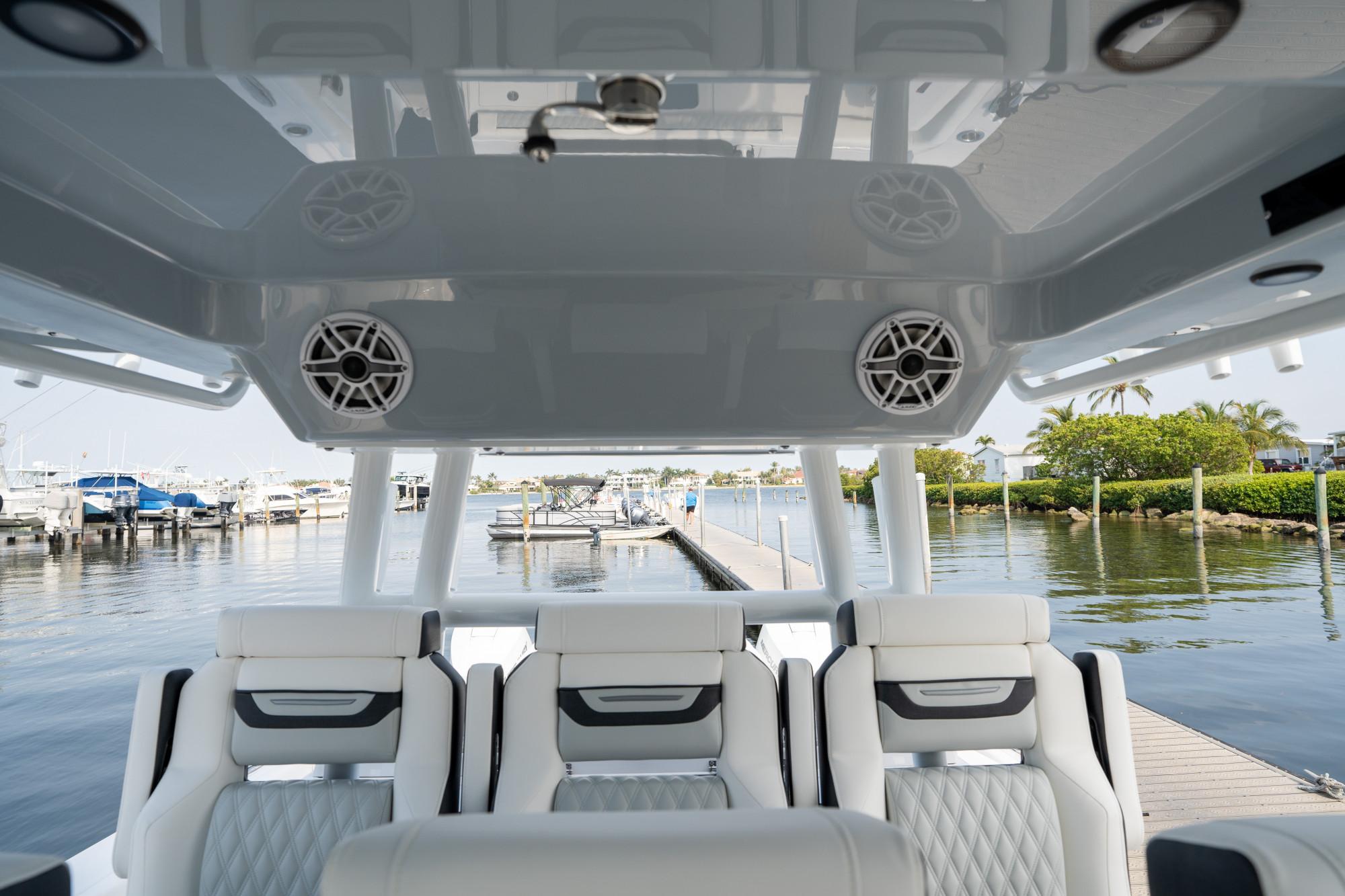 Slide: The Image of 2024 Blackfin 400 CC boat interior with luxurious seating and waterfront view. - 22