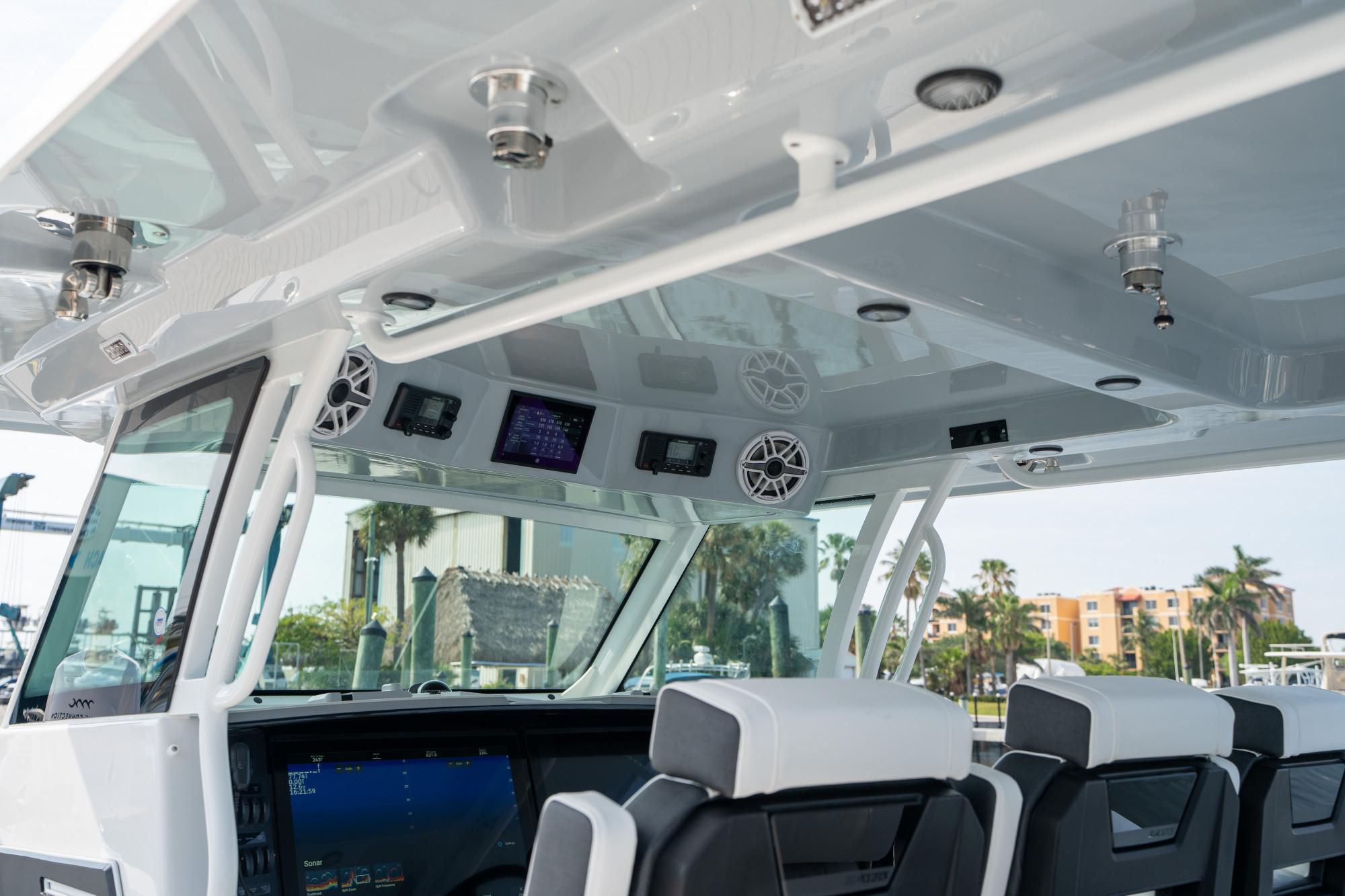 Slide: The Image of Interior view of 2024 Blackfin 400 CC boat with modern controls and seating. - 24