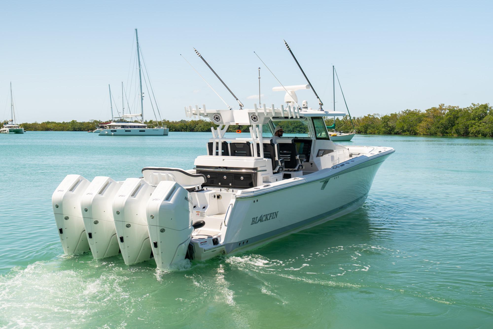Slide: The Image of 2024 Blackfin 400 CC boat with four engines cruising on clear water. - 3