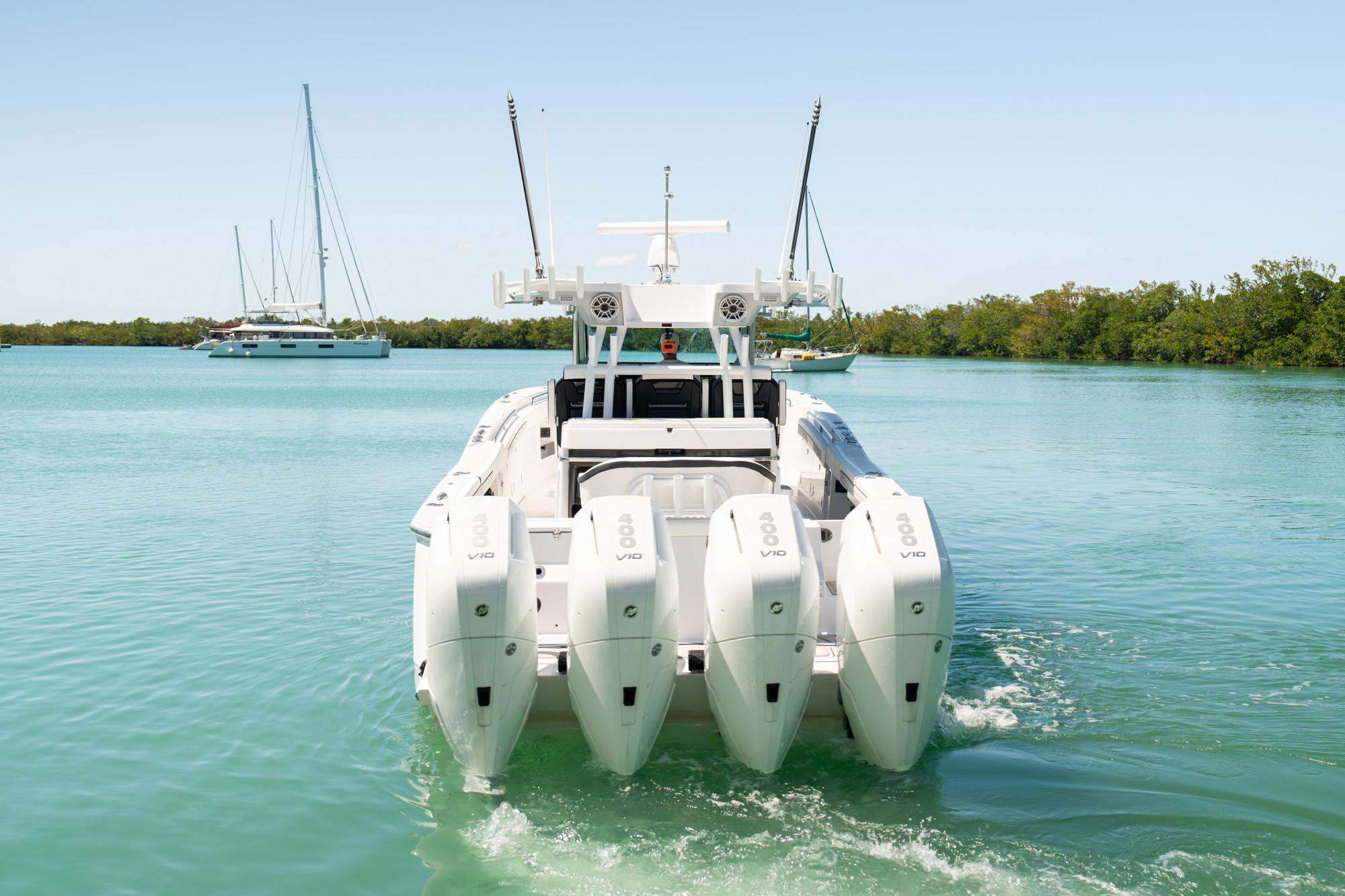 Slide: The Image of 2024 Blackfin 400 CC boat with quad engines cruising on clear water. - 4